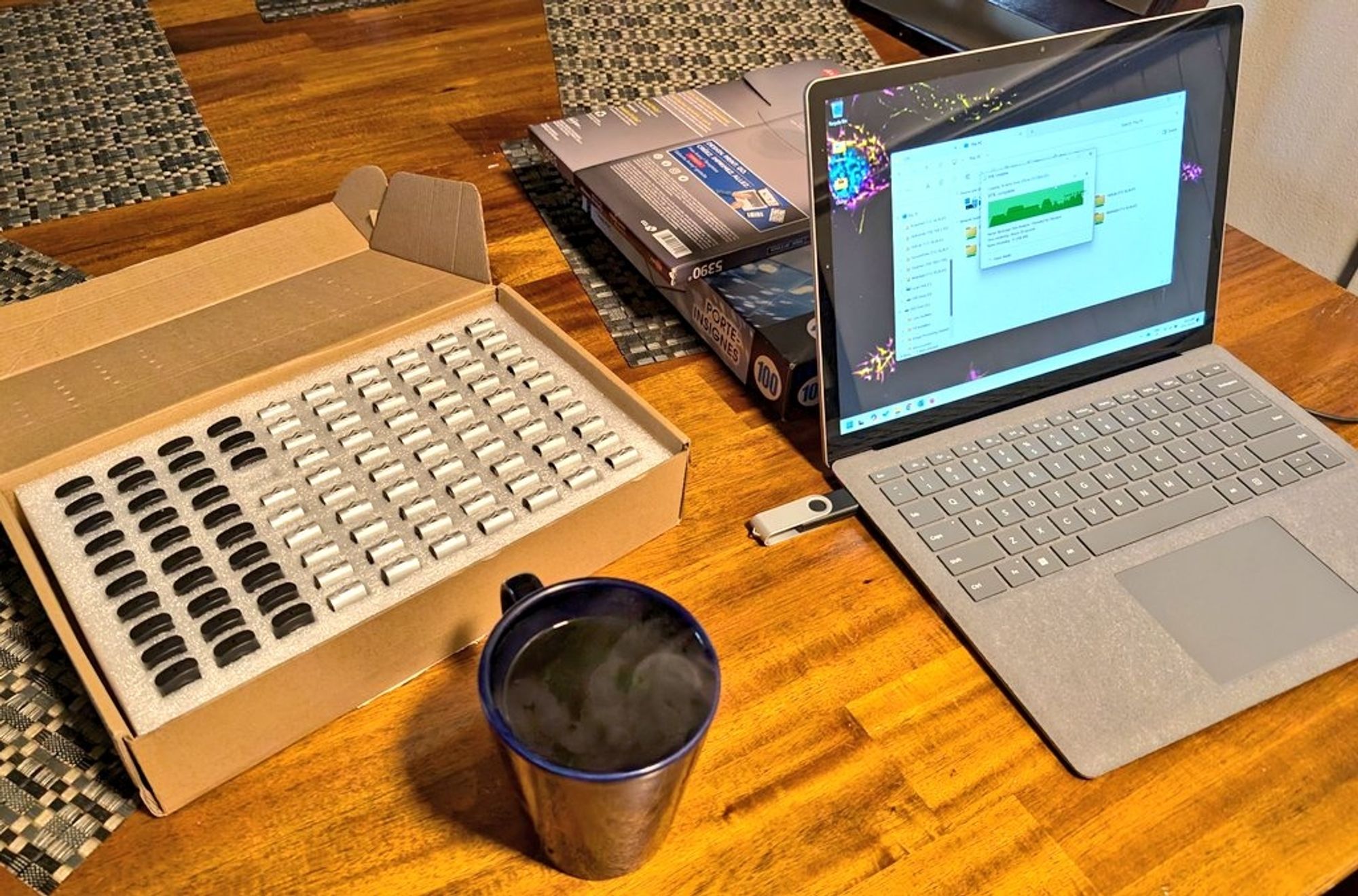 Coffee, laptop, and a bunch of USB drives 