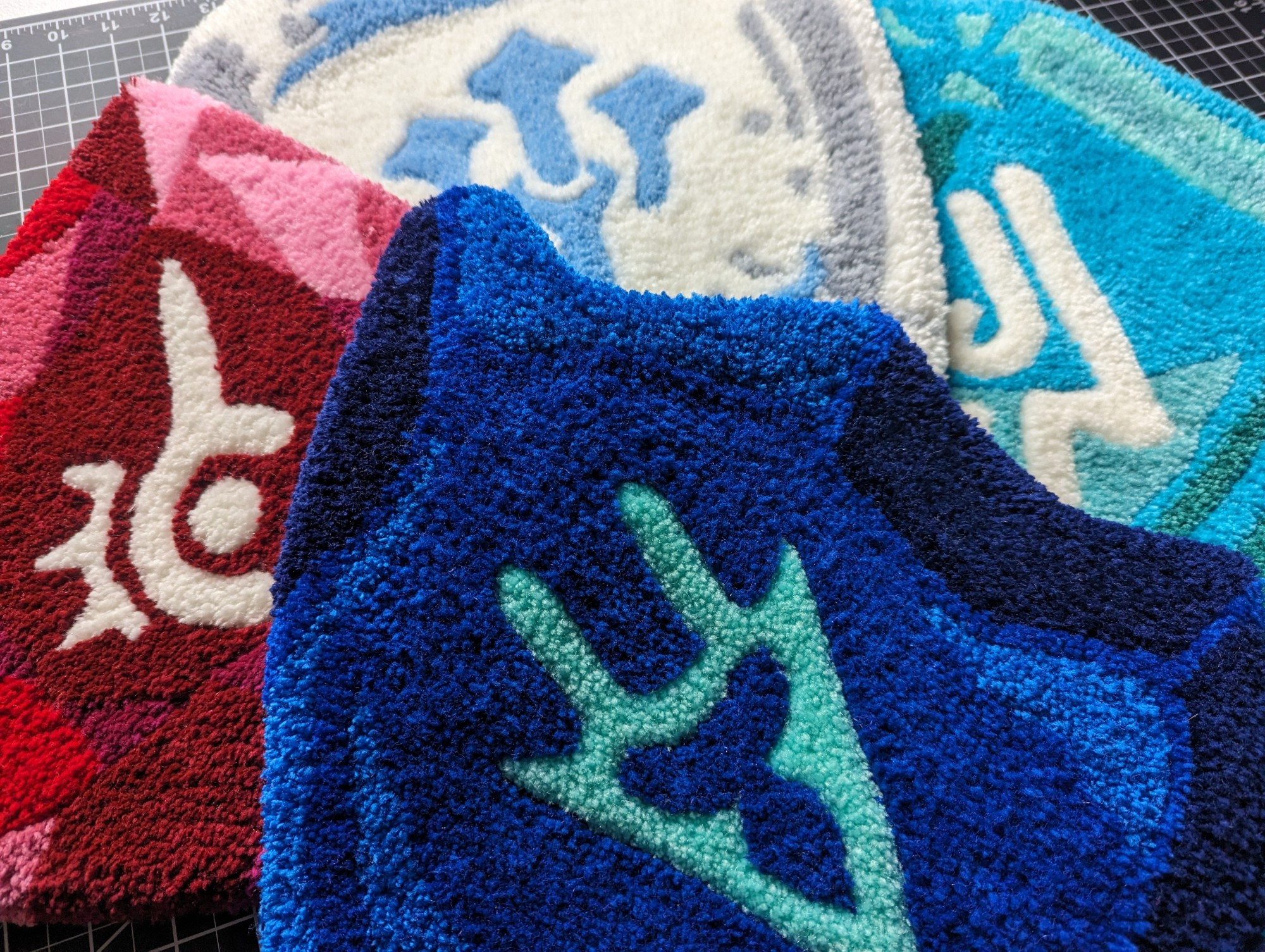 A pile of hand-tufted rugs featuring a Dragoon Soul Crystal, Red Mage Soul Crystal, Sage Soul Crystal, and Machinist Soul crystal.