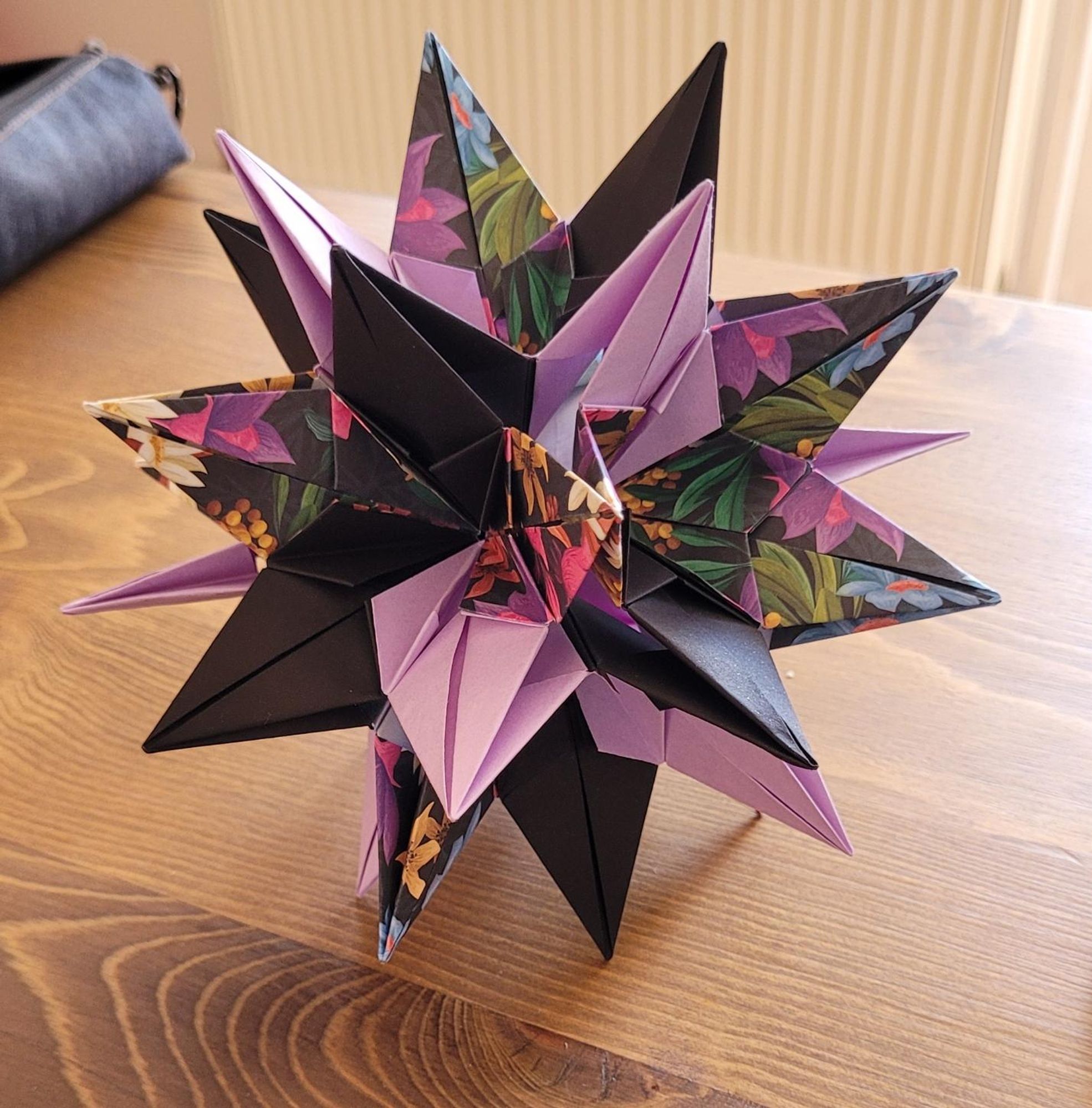 sparaxis kusudama (really cool spikey ball of paper) on a wooden table