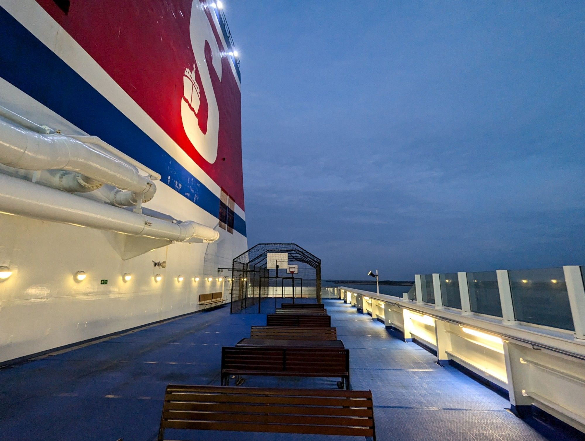 Outside deck. The first light of the day illuminates the bis Stena logo.