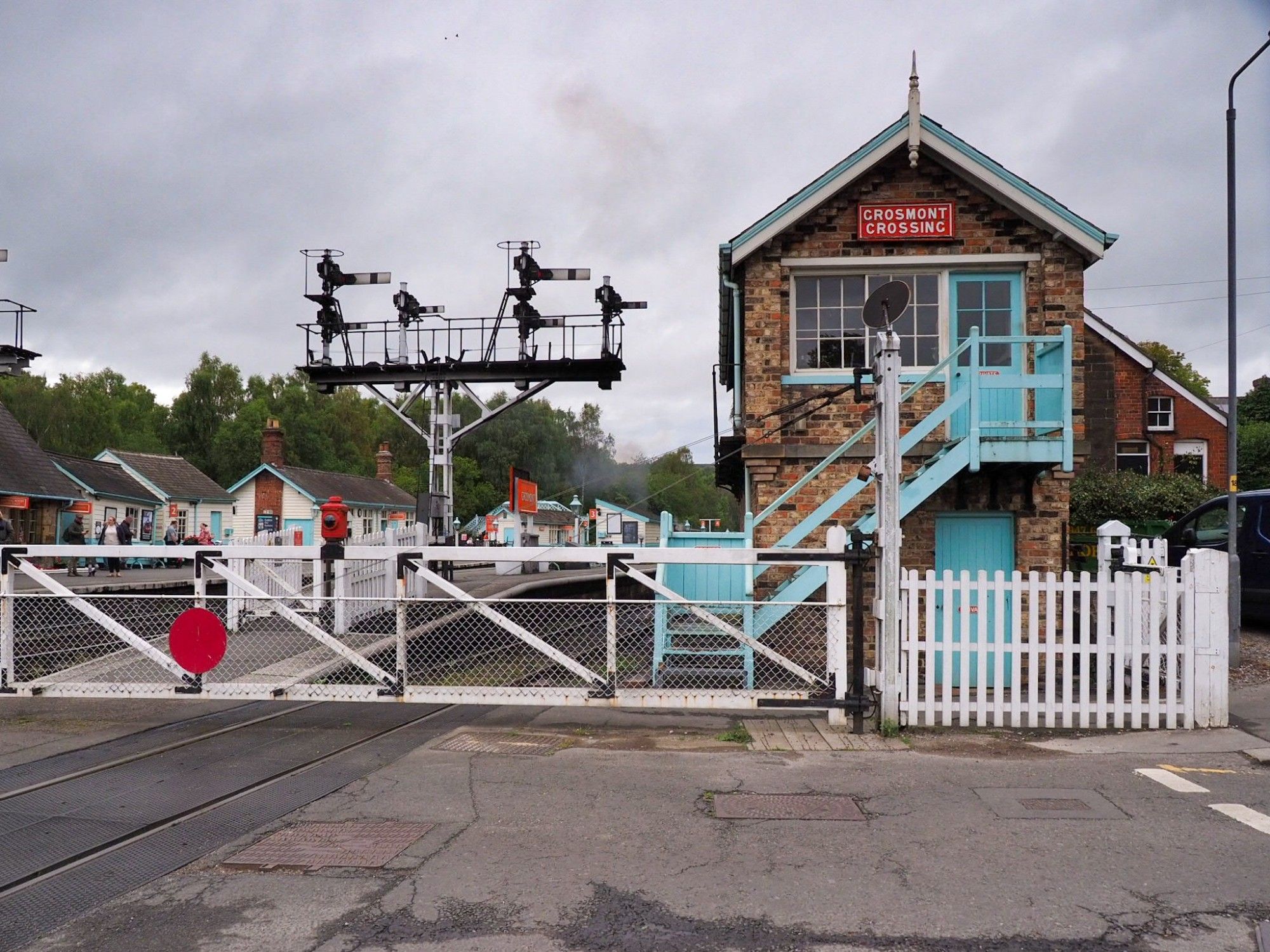 Th signal box with a red sign «Grosmont crossing» and the old level crossing