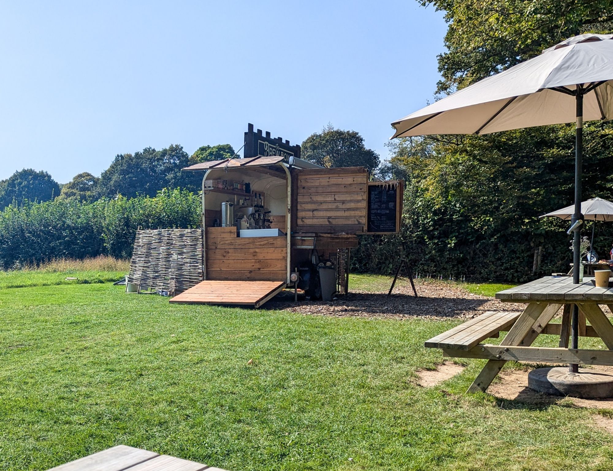 A wooden booth with a coffee machine in it