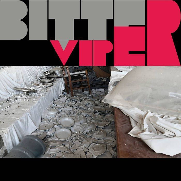 Bitterviper album cover. A river of smashed crockery in between two banks of sheet covered tables.