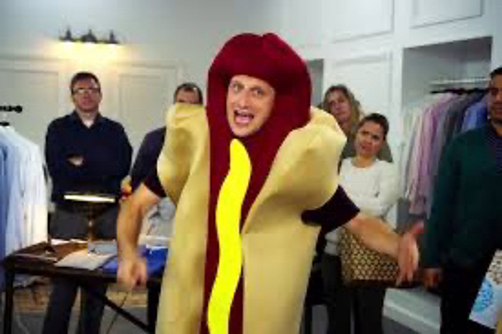 A guy wearing a hot dog suit.