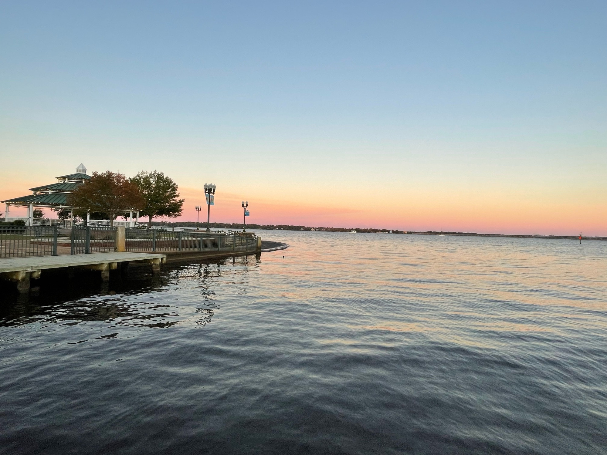 View from a boat dock looking east with a large gazebo the left. Pastels across the river where the moon will rise. 