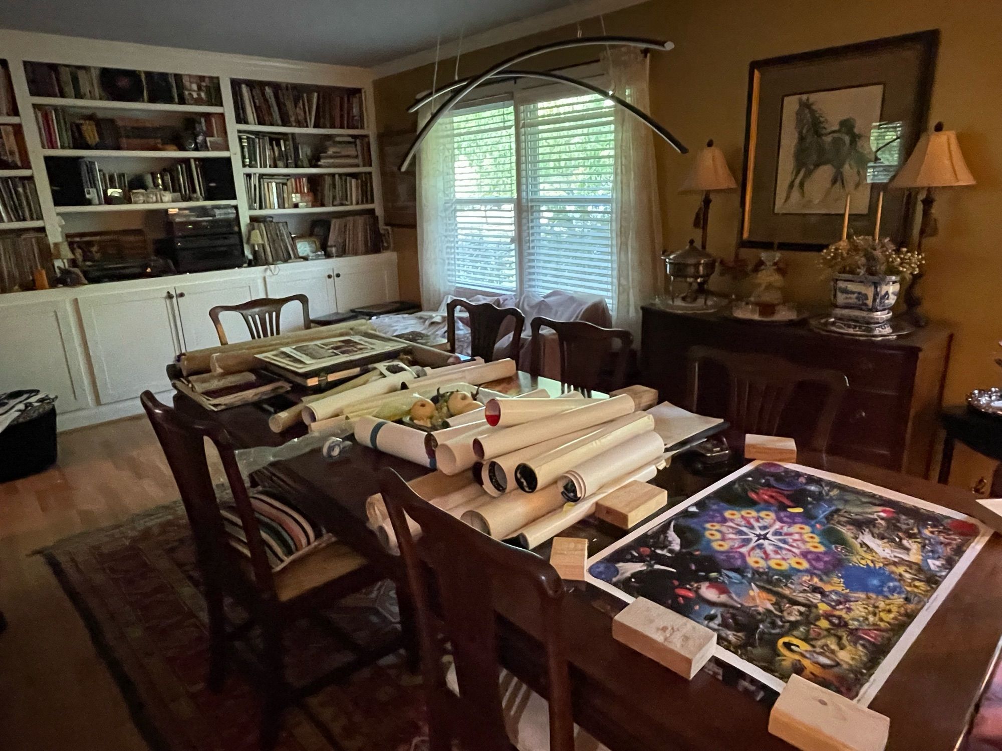 Diningroom table with many rolled up posters