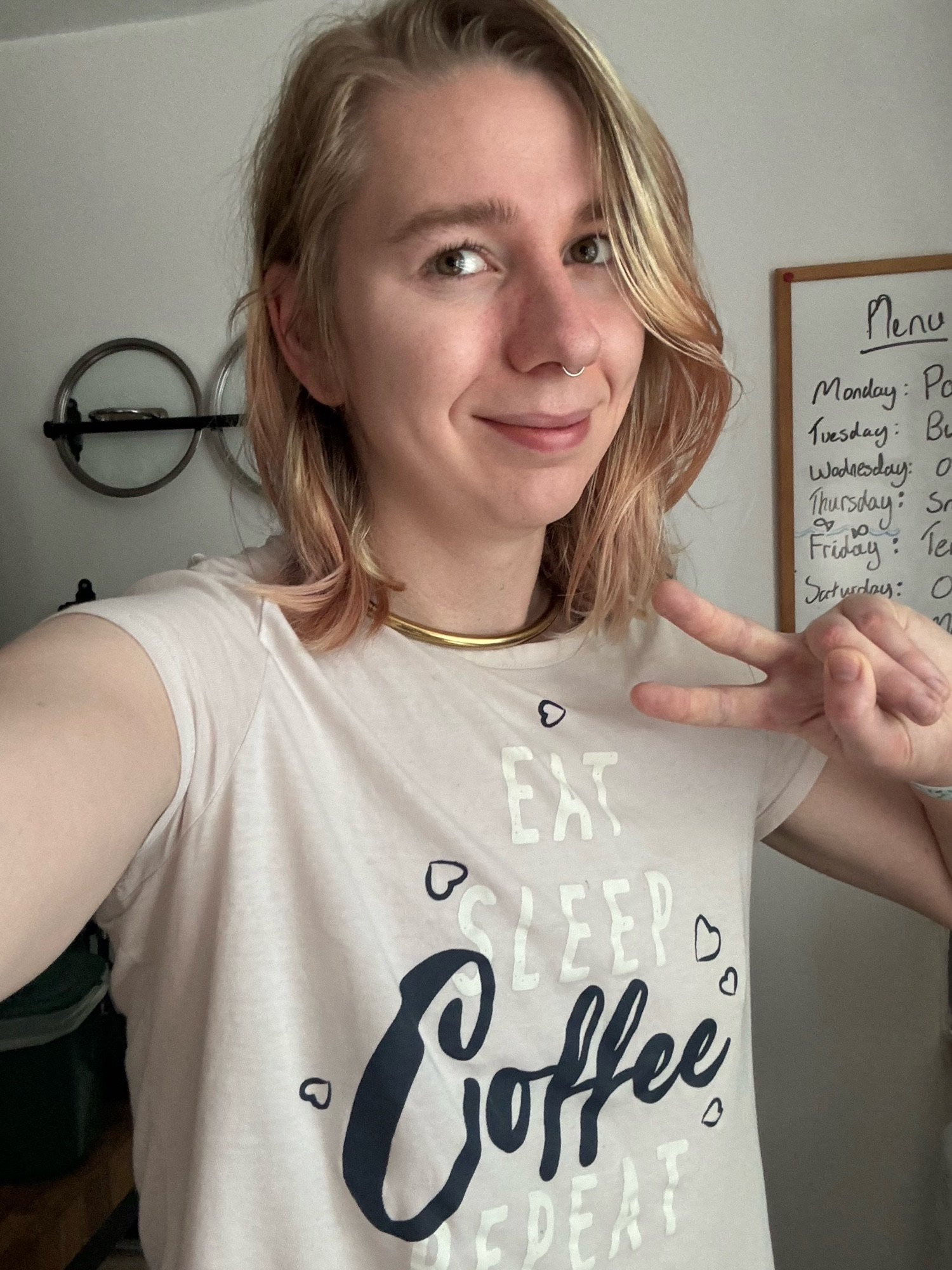 maisie in a t shirt that says “eat sleep coffee repeat”