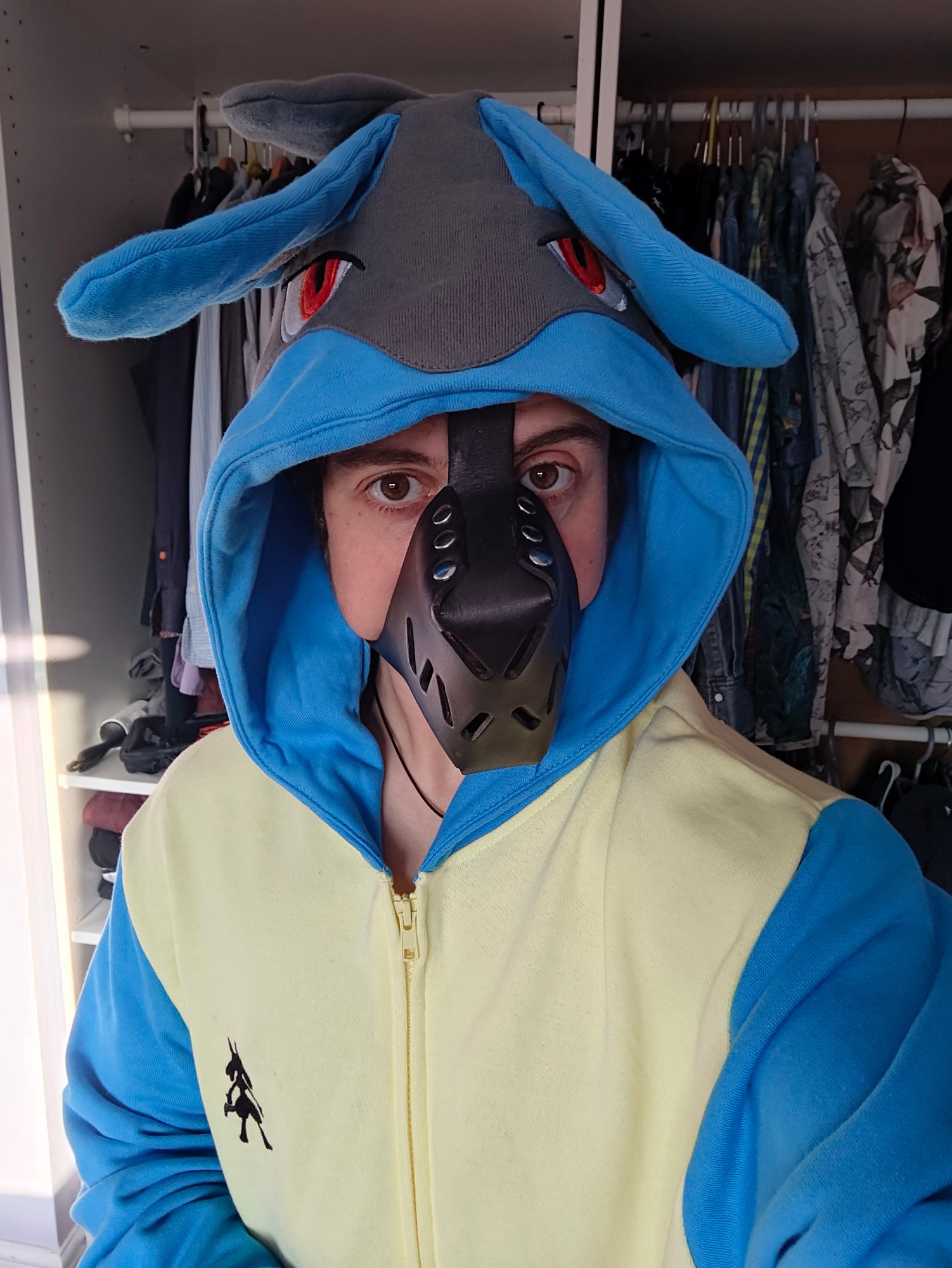 Alix wearing a Lucario hoodie and a chompy muzzle