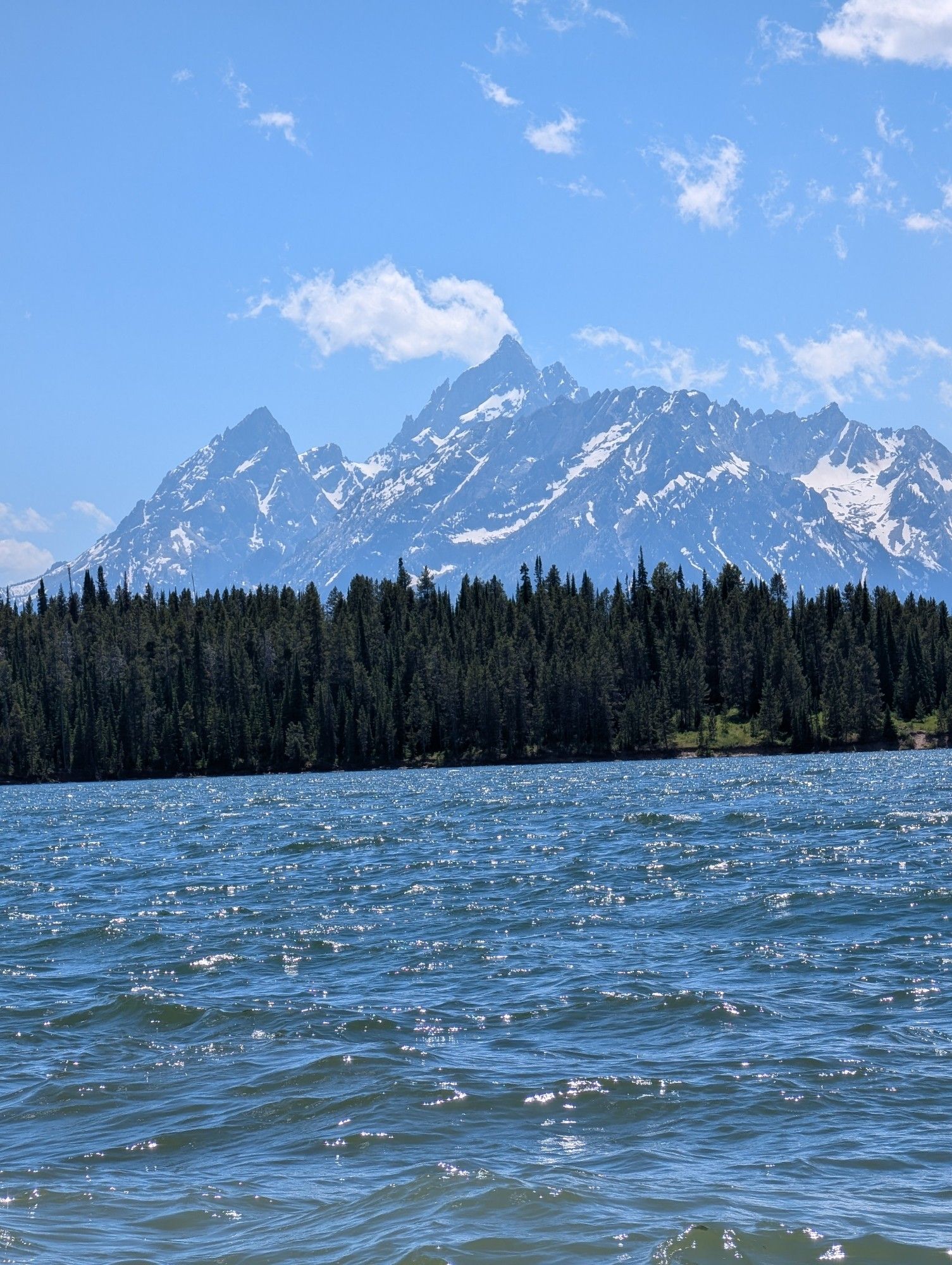 A photo of the Grand Tetons mountain range in Wyoming. Taken from the edge of Lake Jackson, which sits at the foot of the range.