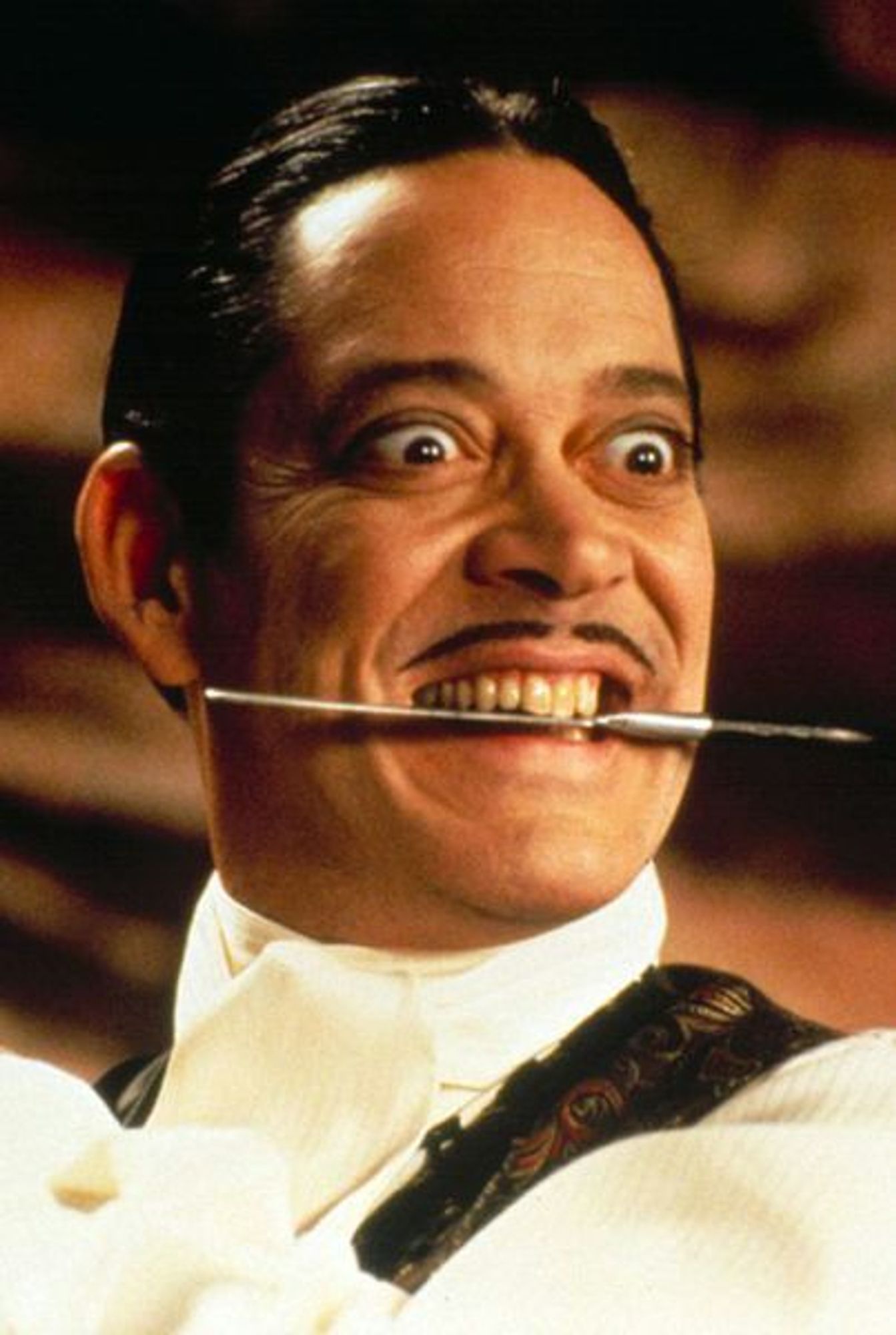 Gomez Addams, perhaps the only tolerable aristocrat, dagger between his teeth.