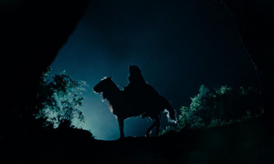 Ringwraith atop his fell steed. Cloaked in black, silhouetted by the moonlight.