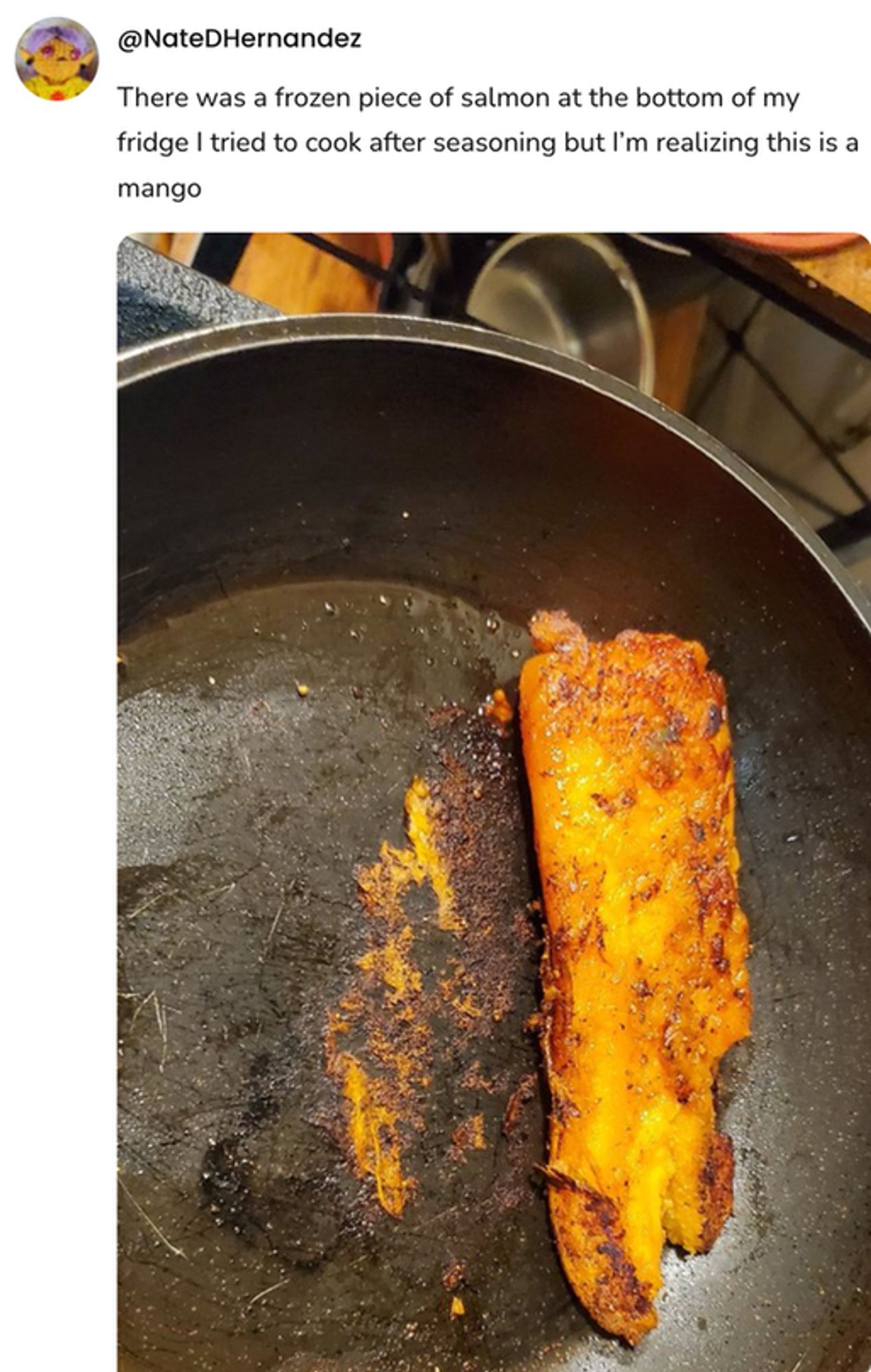  A social post from @NateDHernandez that says: There was a frozen piece of salmon at the bottom of my fridge I tried to cook after seasoning but I'm realizing this is a mango