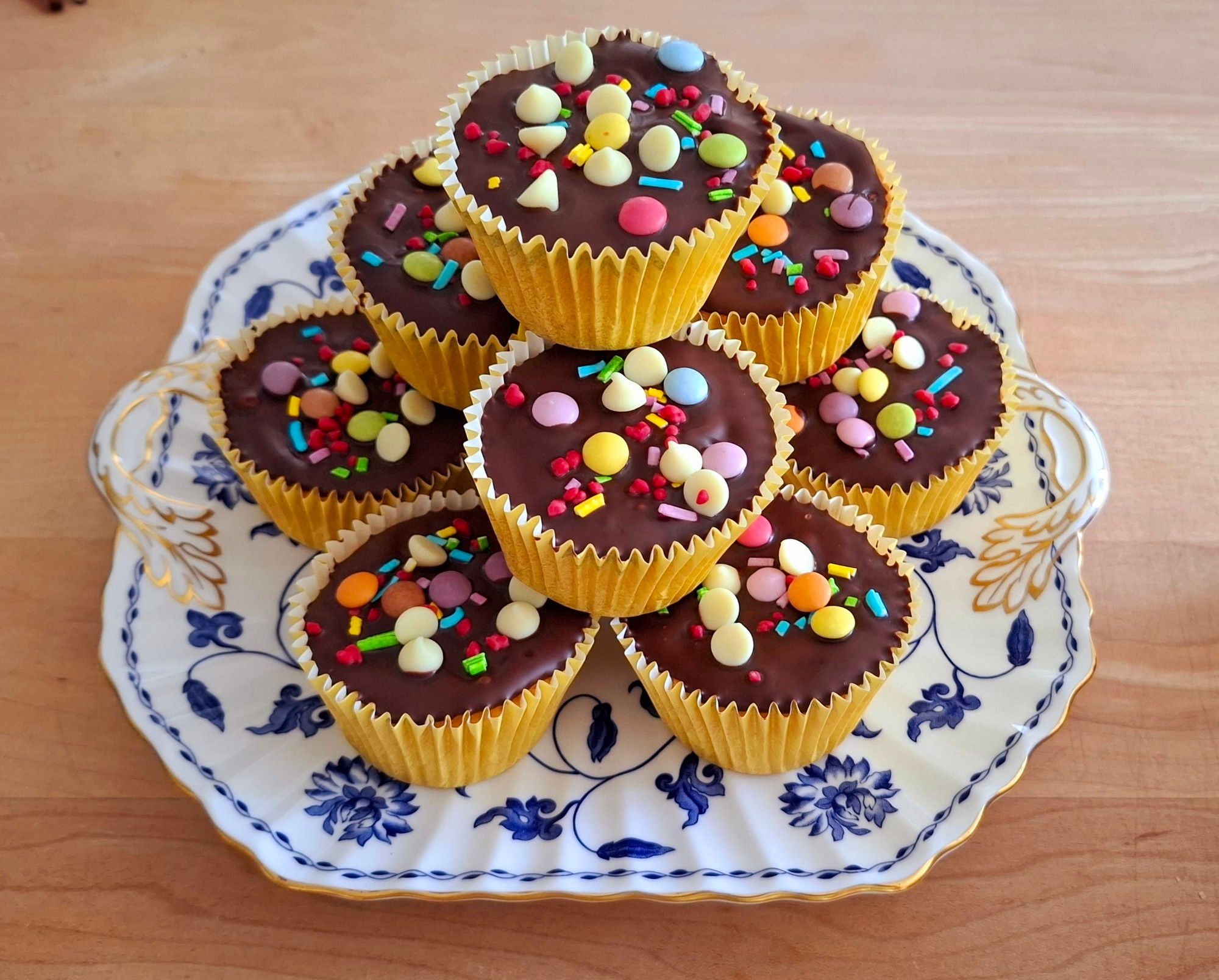 Orange buns topped with chocolate rainbow drops baked by @alexbobsleigh.bsky.social