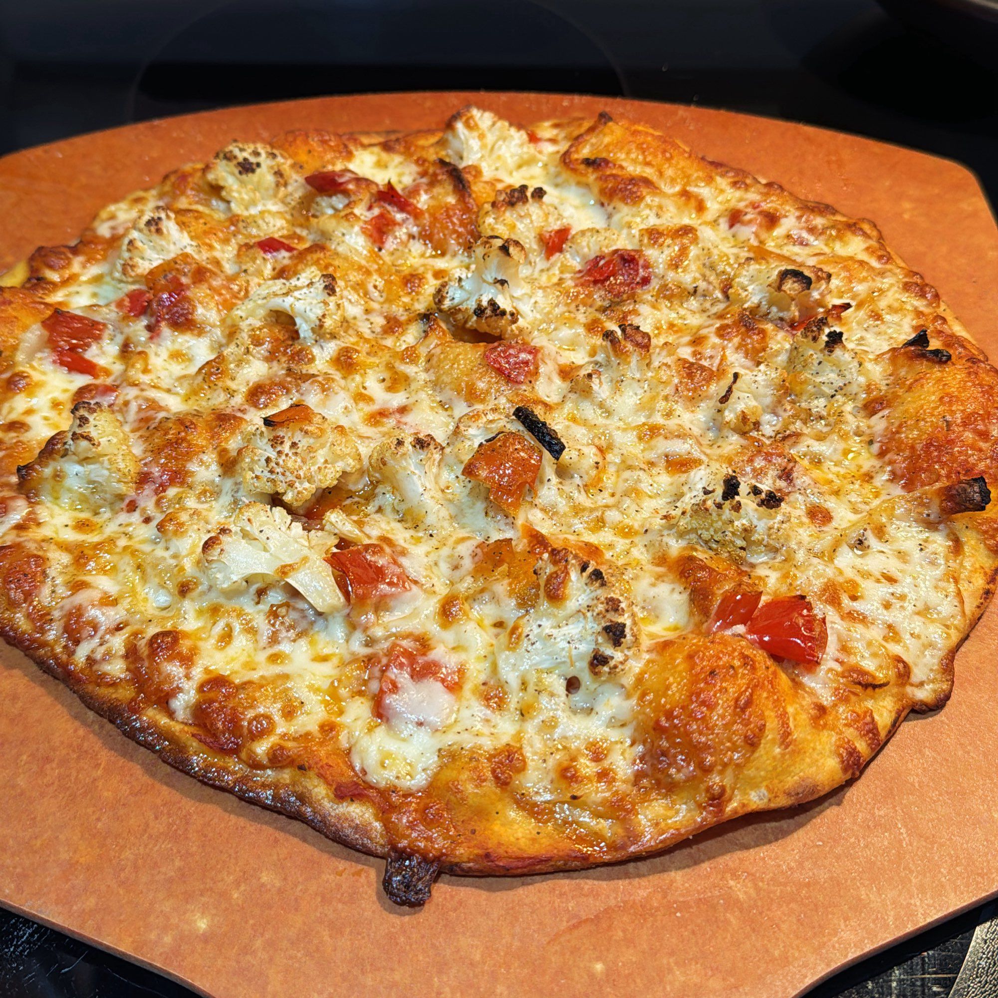 A thin crust pizza with roasted cauliflower, caramelized onions, and pickled peppers.