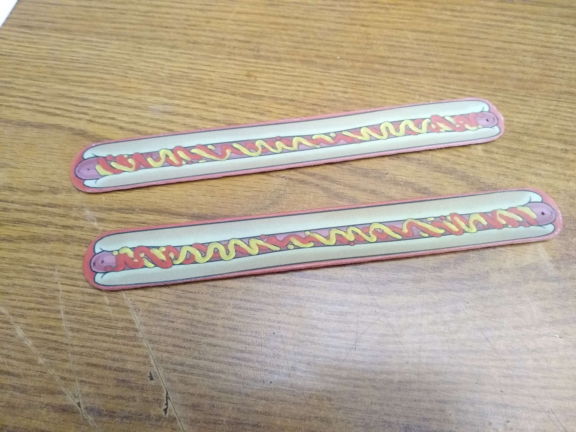 2 Hotdog Slap Bracelets, fully extended.