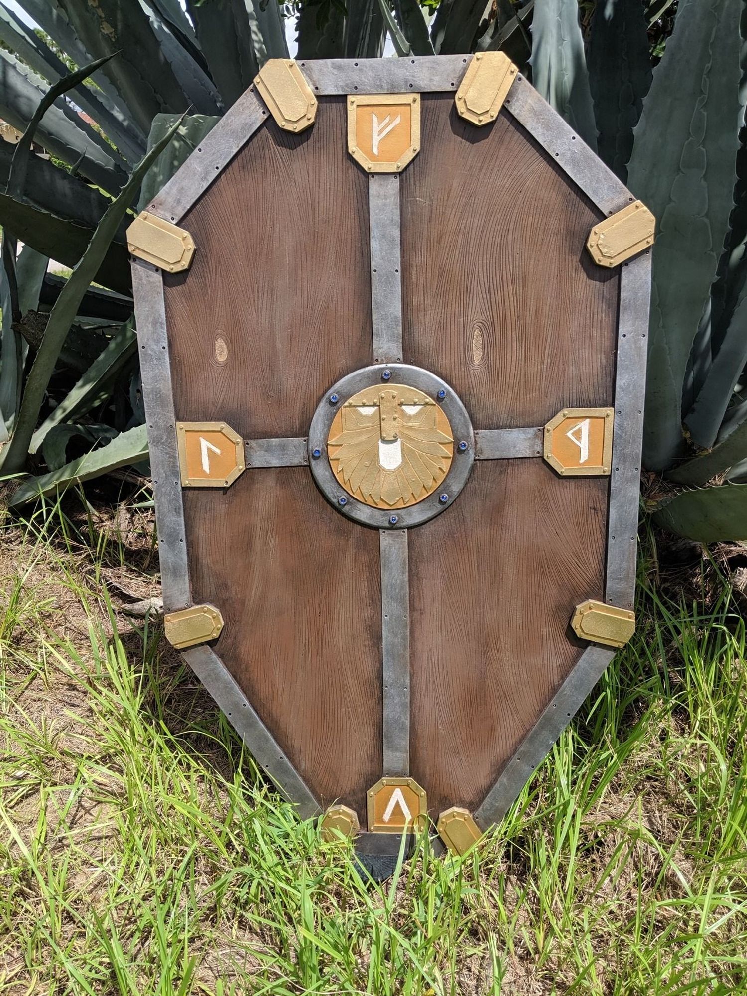 A Large Dwarven Tower Shield with glowing runes on the front and a face in the middle.