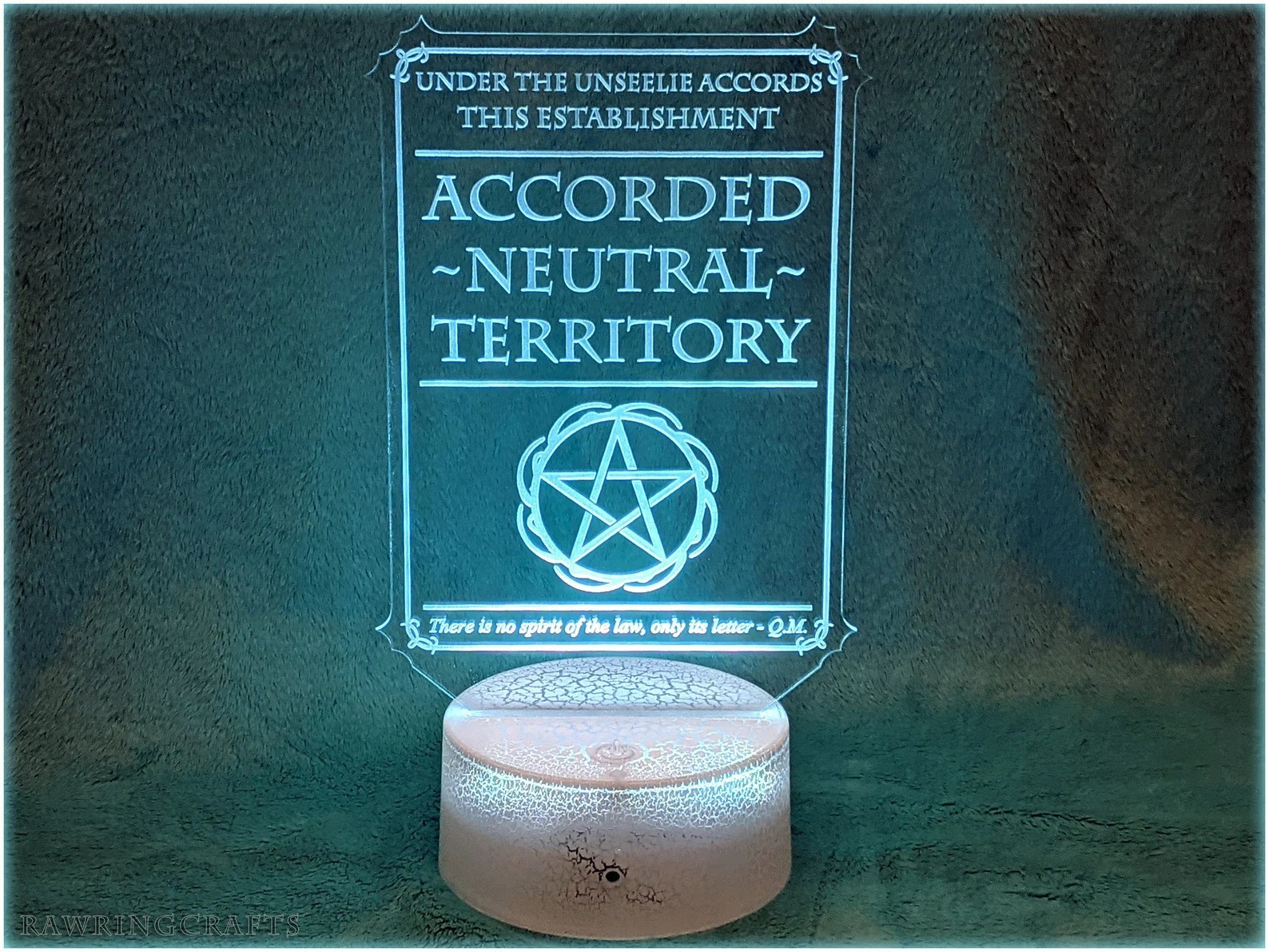 A light up sign that reads from top to bottom.
UNDER THE UNSEELIE ACCORDS THIS ESTABLISHMENT 
ACCORDED NEUTRAL TERRITORY
There is no spirit of the law, only its letter -QM