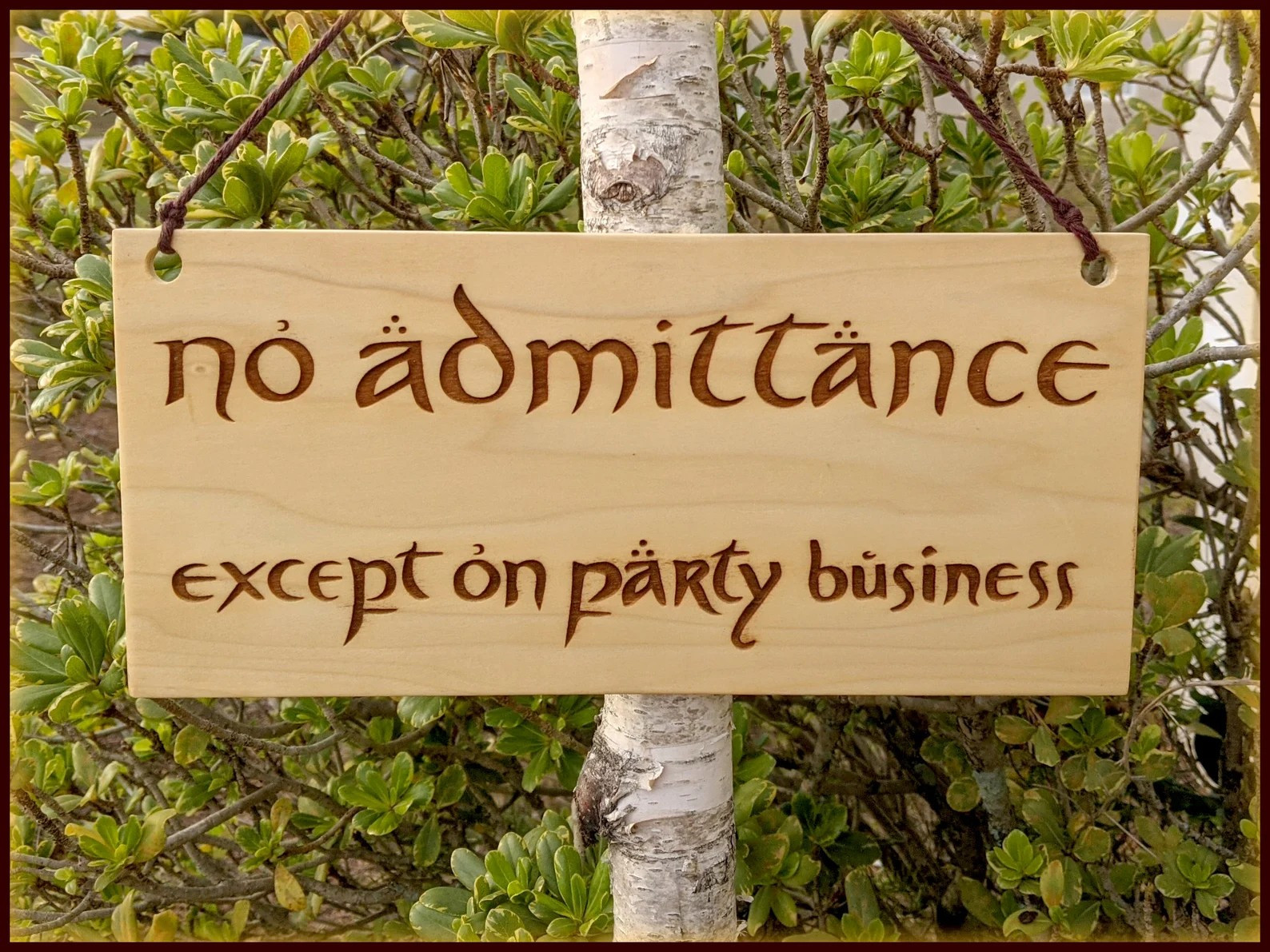 The "NO ADMITTANCE, Except on party business" Sign, Bilbo puts up in front of Bag End in anticipation for his 111th birthday, its made of Aspen, and is hanging on a Tree. 