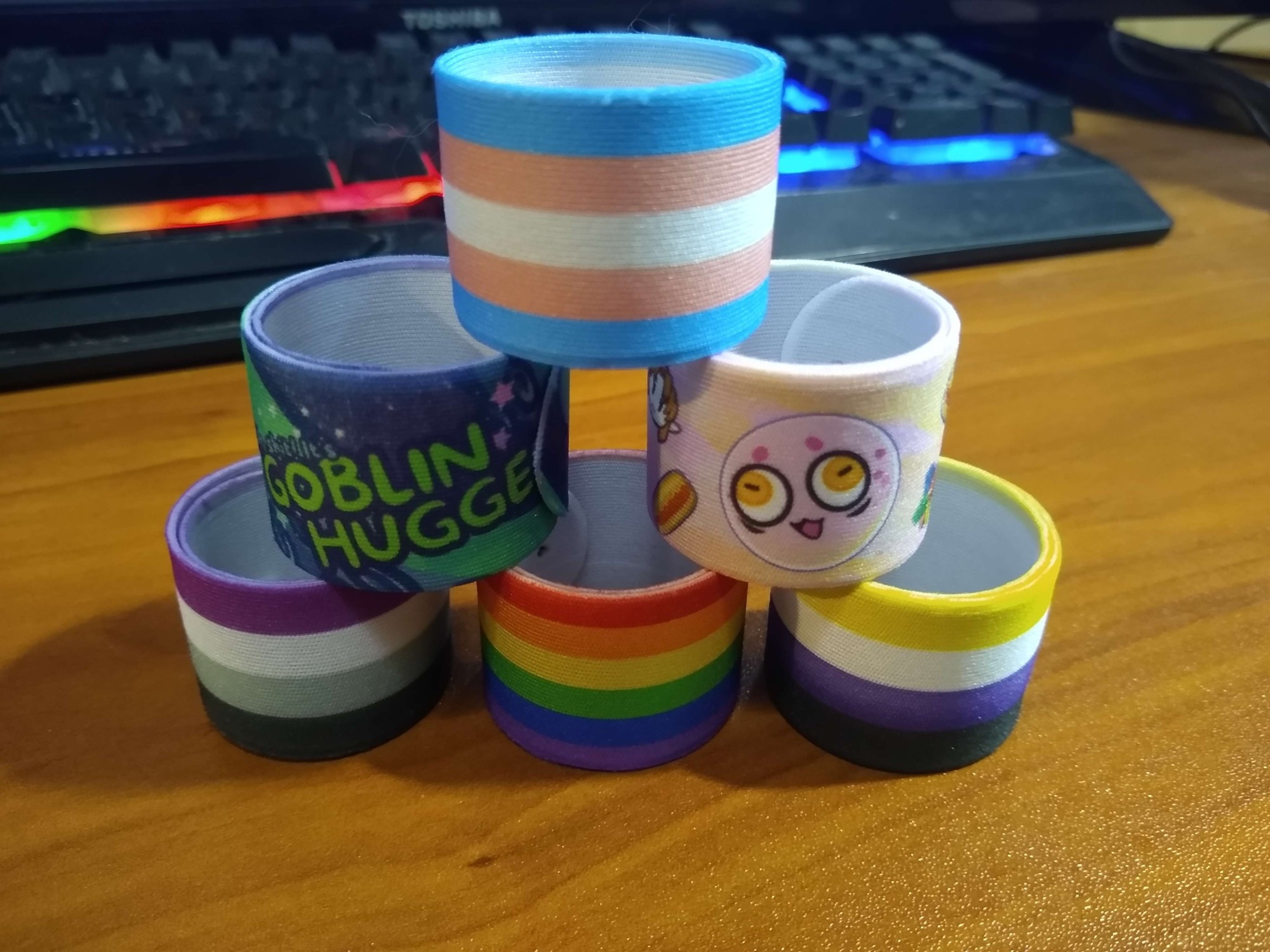 Trans,  Nonbinary, Pank, Goblinhugger, LGBTQIA+ and Nonbinary Slap Bracelets. All rolled up