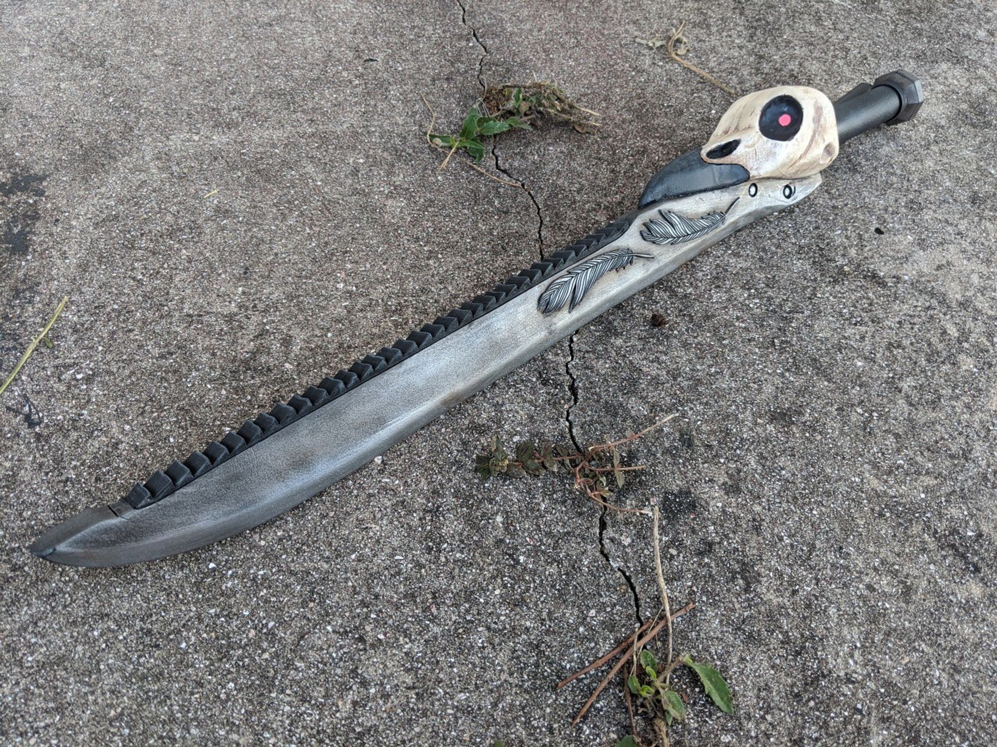 A Sword with a Raven Skull, with Feathers on the Blade, and LIT Glow in the Dark Eyes