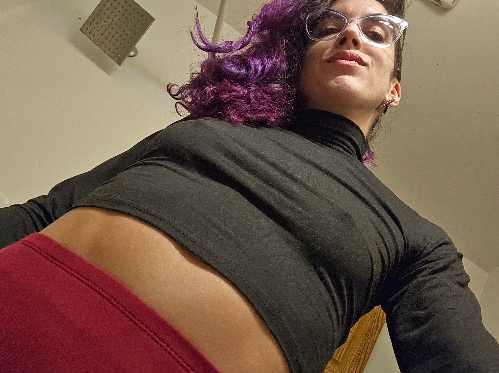 It's me taking a selfie from an under angle because I looked at my boobs and went "ok nippy" 

I got on red leggings that go up to my waist. Then I got on a black turtle neck long sleeved crop top that's sized XS and it makes my little boobs look great. Pffft. I also got purple hair now yay!