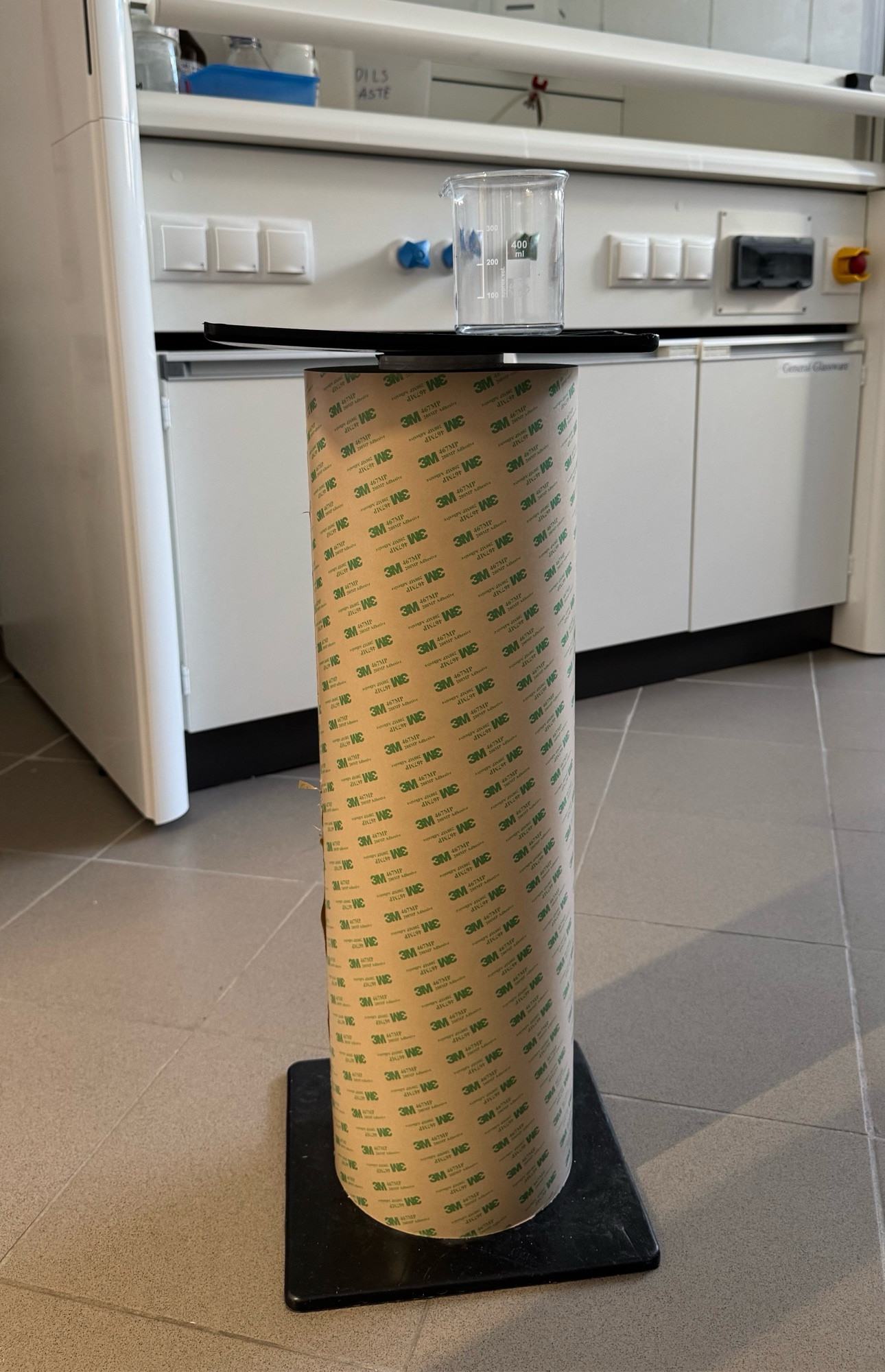 A very large roll of tape - 60 cm tall and 20 cm diameter.  400 ml beaker for scale. 
Photo taken in a laboratory with a fume hood in the background.