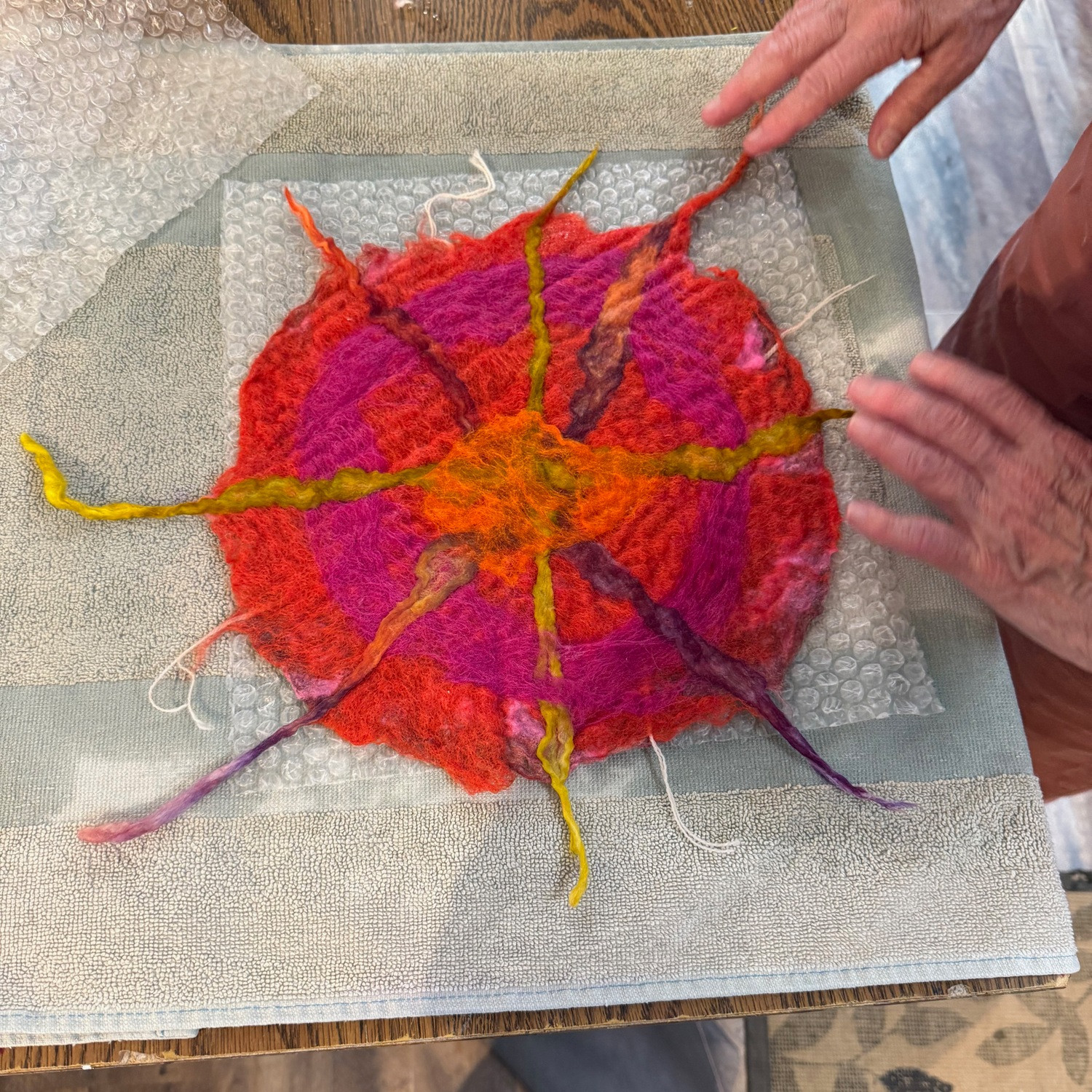 A red, gold, and purple sun in progress.