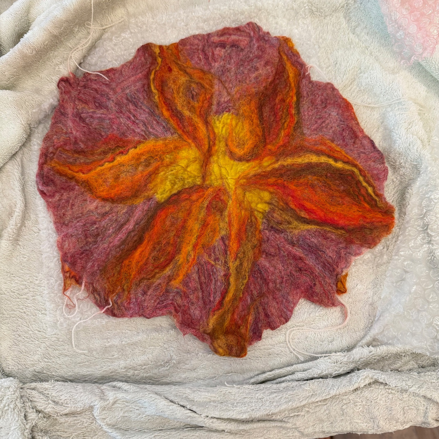 A purple, orange, and gold sun in progress.