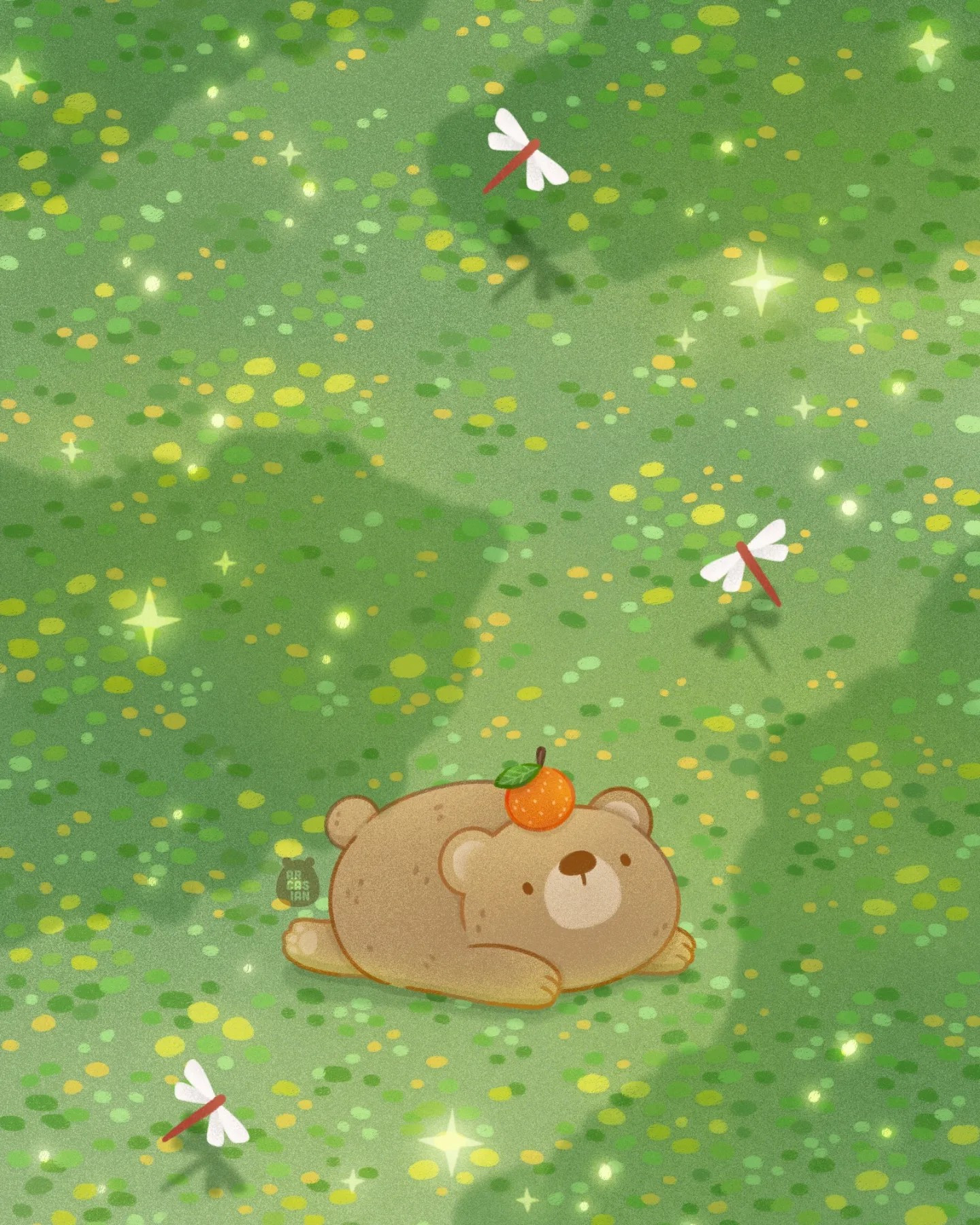 Artwork of a chubby brown bear lying in a green field with an orange sitting atop its head. There are three red dragonflies flying around it amongst little golden sparkles.