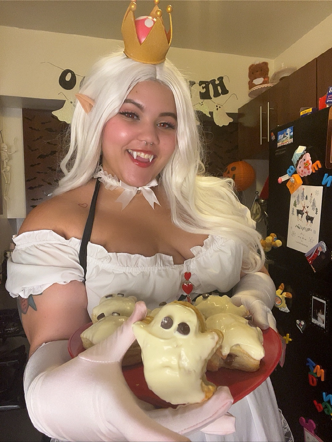 cosplay of Boosette in a maid outfit presenting a ghost pastry