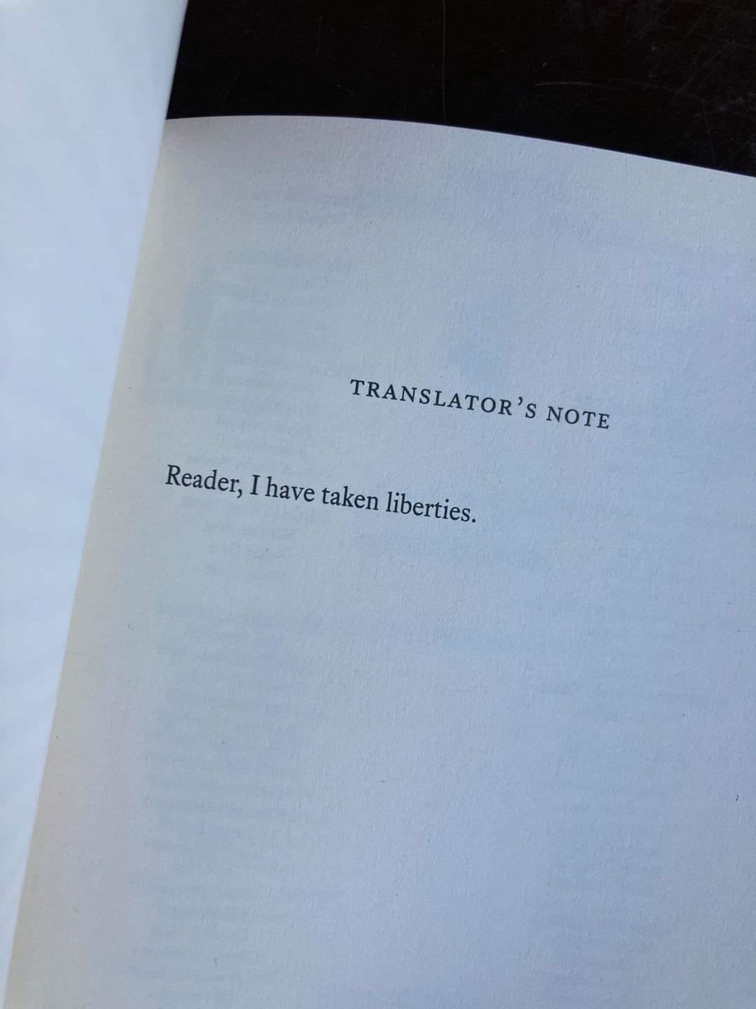 Photo of a book open to the "Translator's Note," which says, "Reader, I have taken liberties."