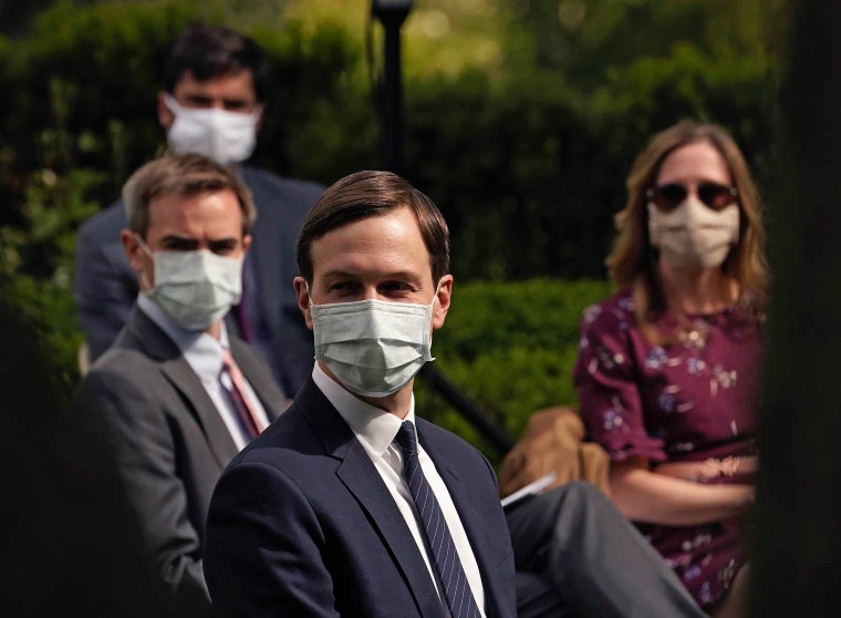 Jared Kushner and entourage wearing masks