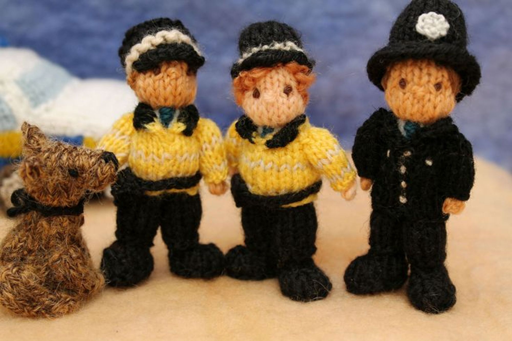 A collection of police figures made of yarn.