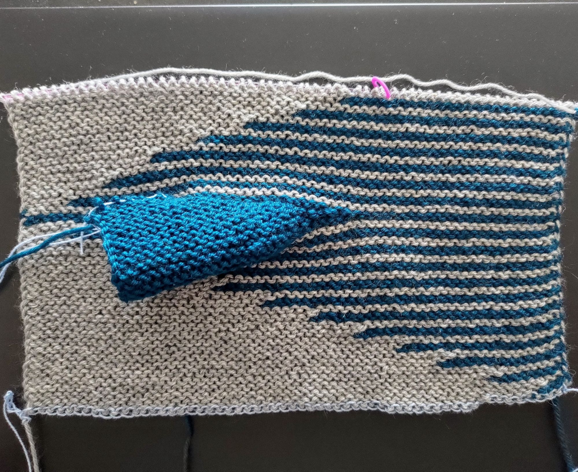 Garter stitch knitting in grey and teal