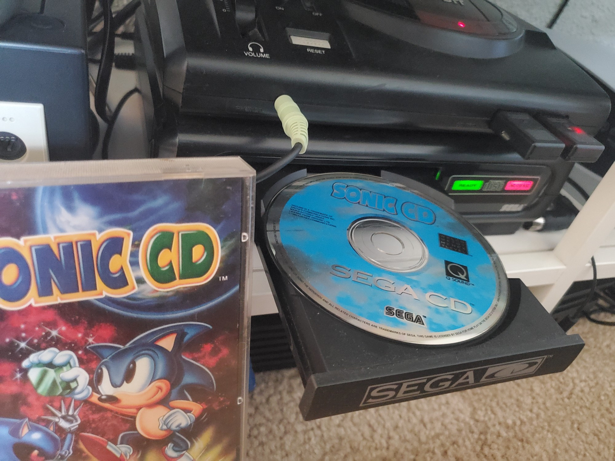 The Sega CD with disk tray opened with the Sonic CD game