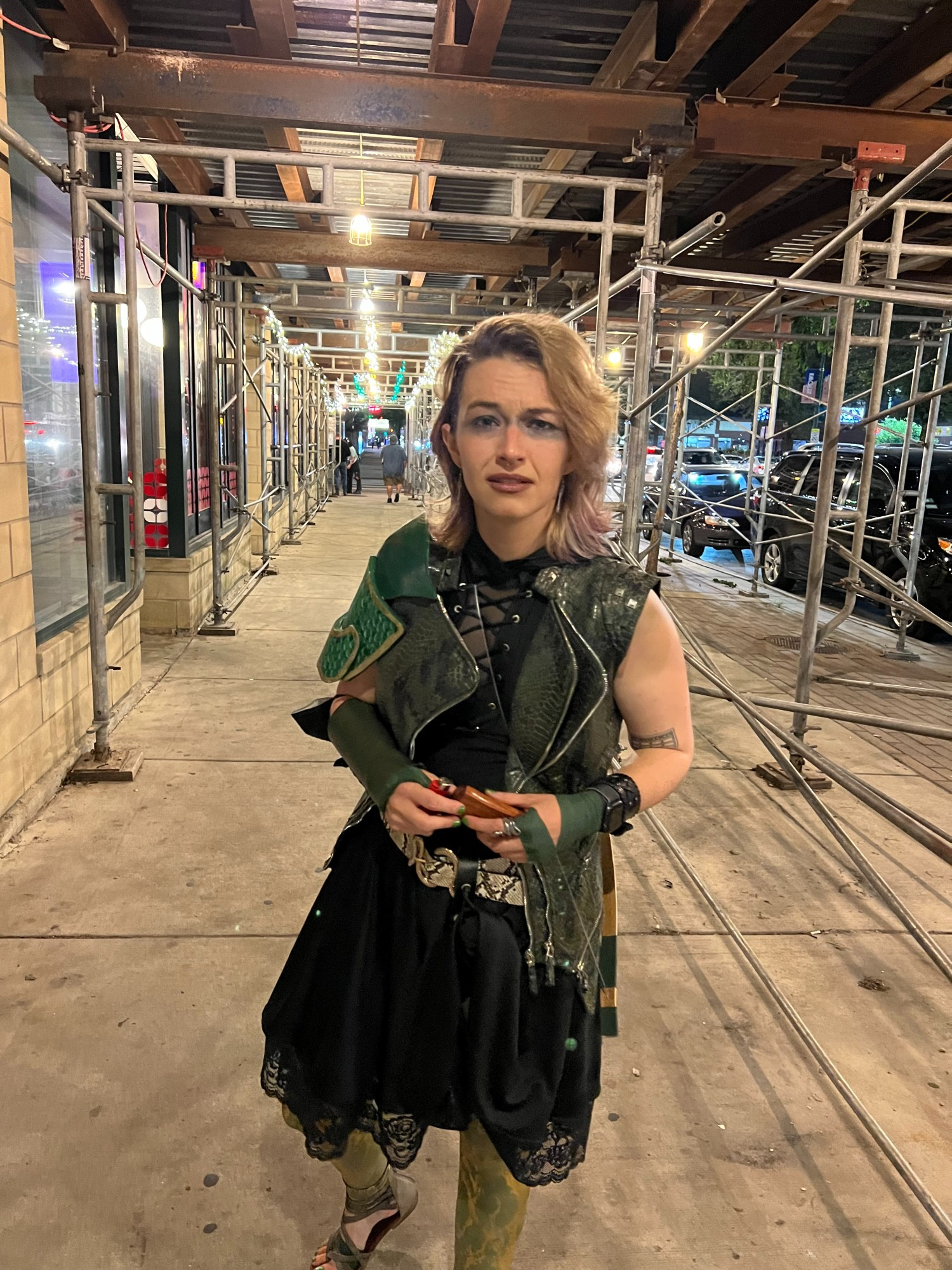 Claire, dressed as Egwene Kindleaf from Not Another D&D Podcast, stands inside scaffolding, sneers to camera. 