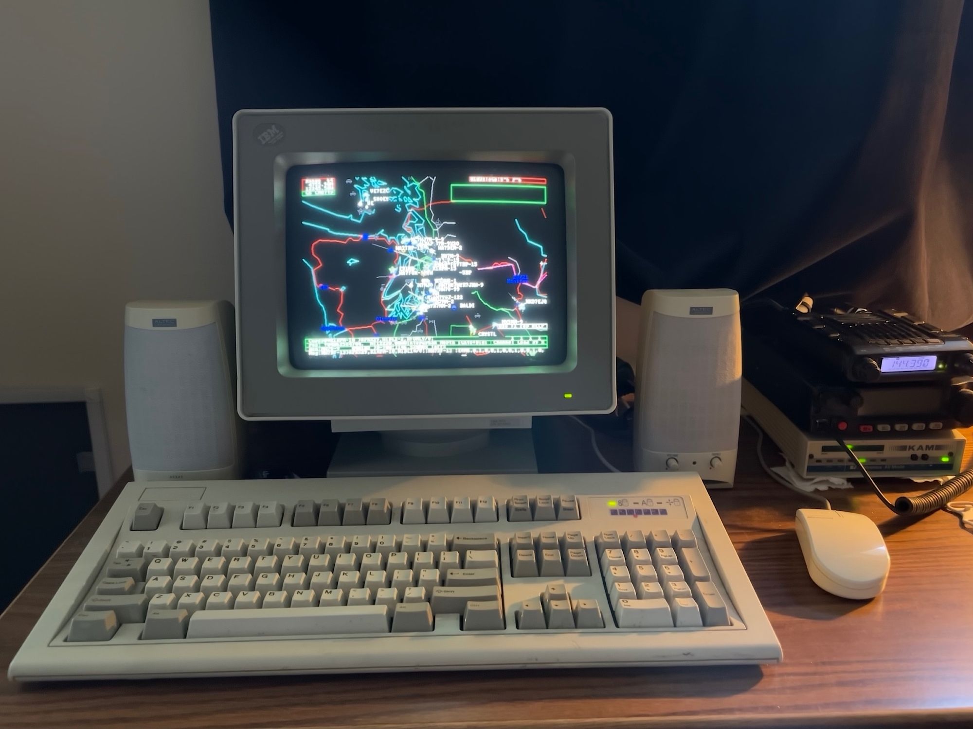 Vintage DOS computer screen showing a map of the Puget Sound region with several ham radio call signs labelled. The program is APRSdos.