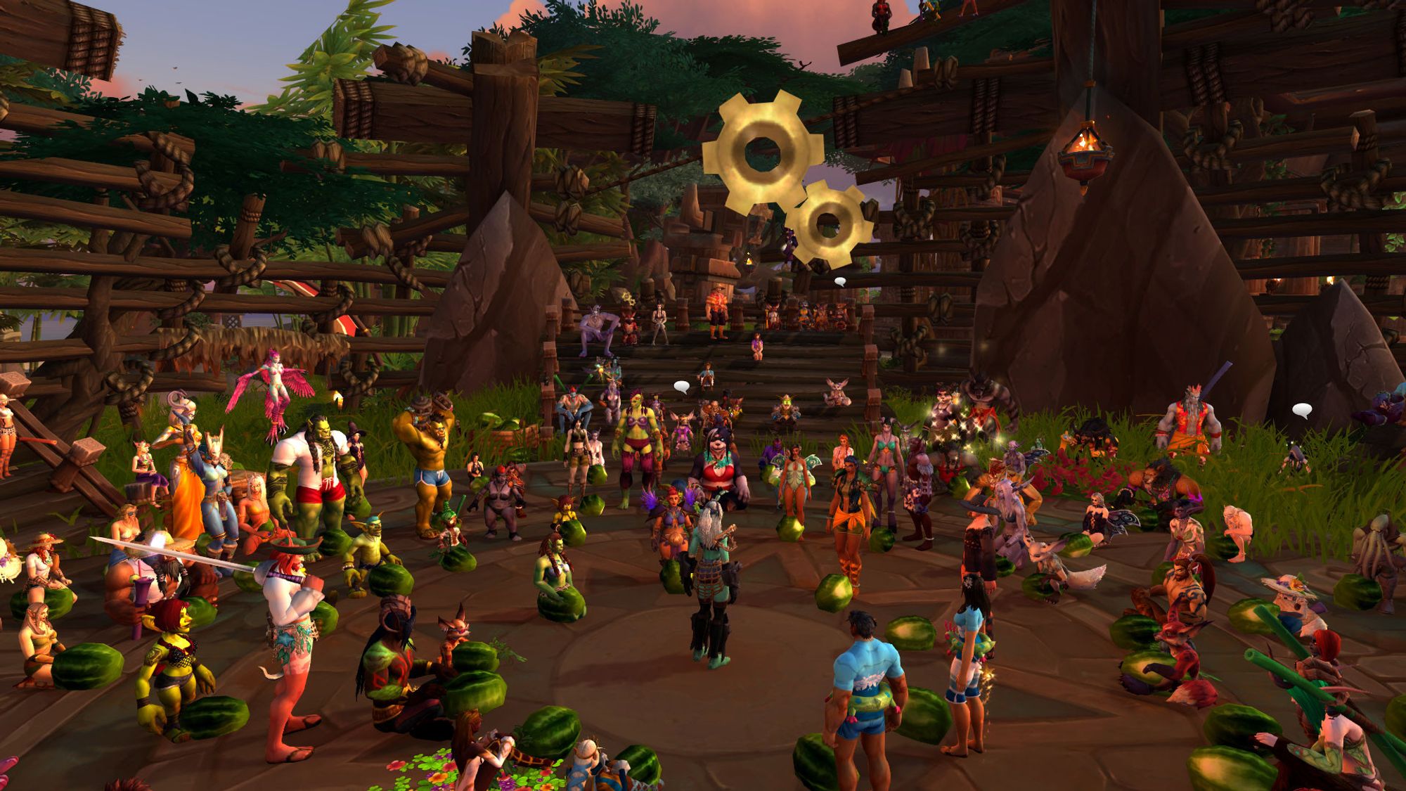 A Warcraft screenshot of a wide variety of characters in a worn wooden arena on a tropical island, many sitting in front of watermelons set on the ground.