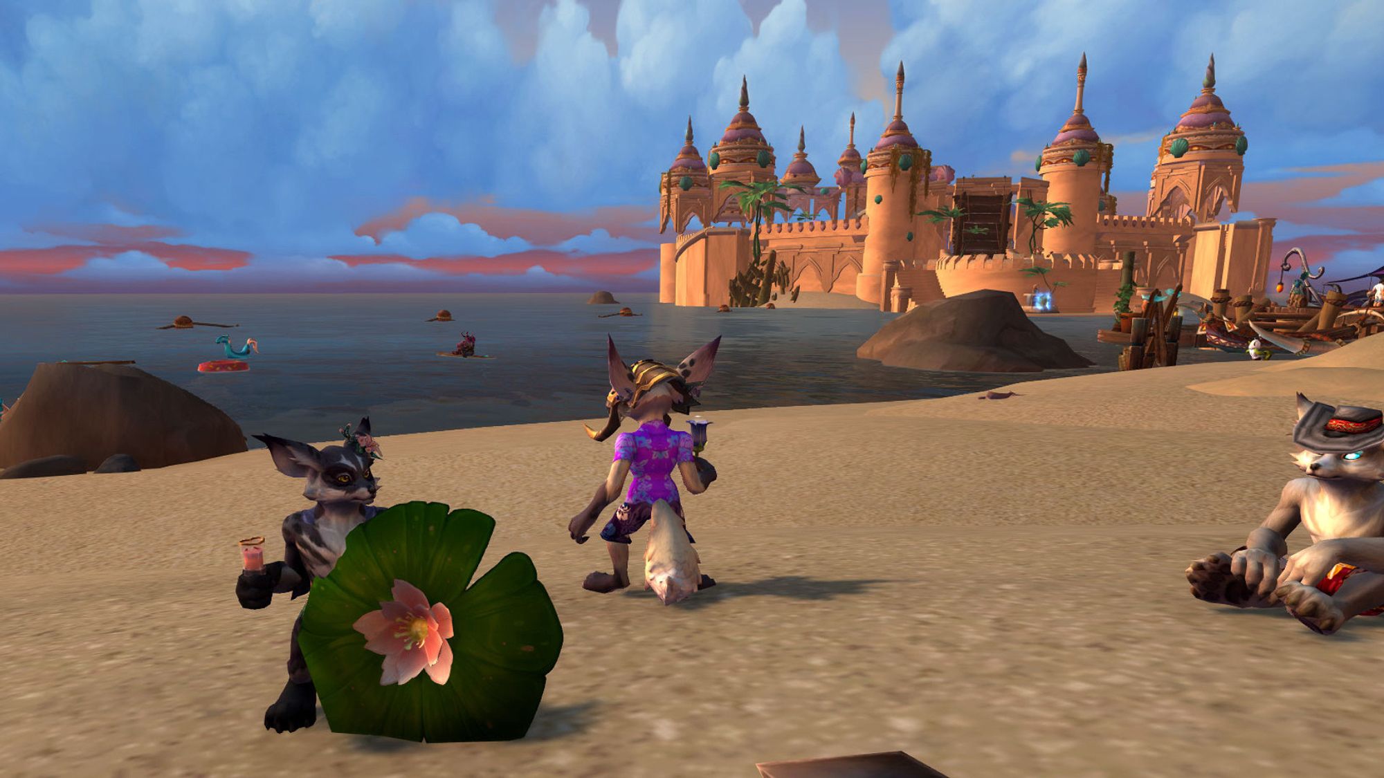 A Warcraft screenshot of a black furred vulpera holding a pink juice in a heart shaped glass and a lily pad parasol, with a cherry blossom tucked behind his ear. He's at the beach, and there's a dramatic life sized sand castle is off in the distance behind him.