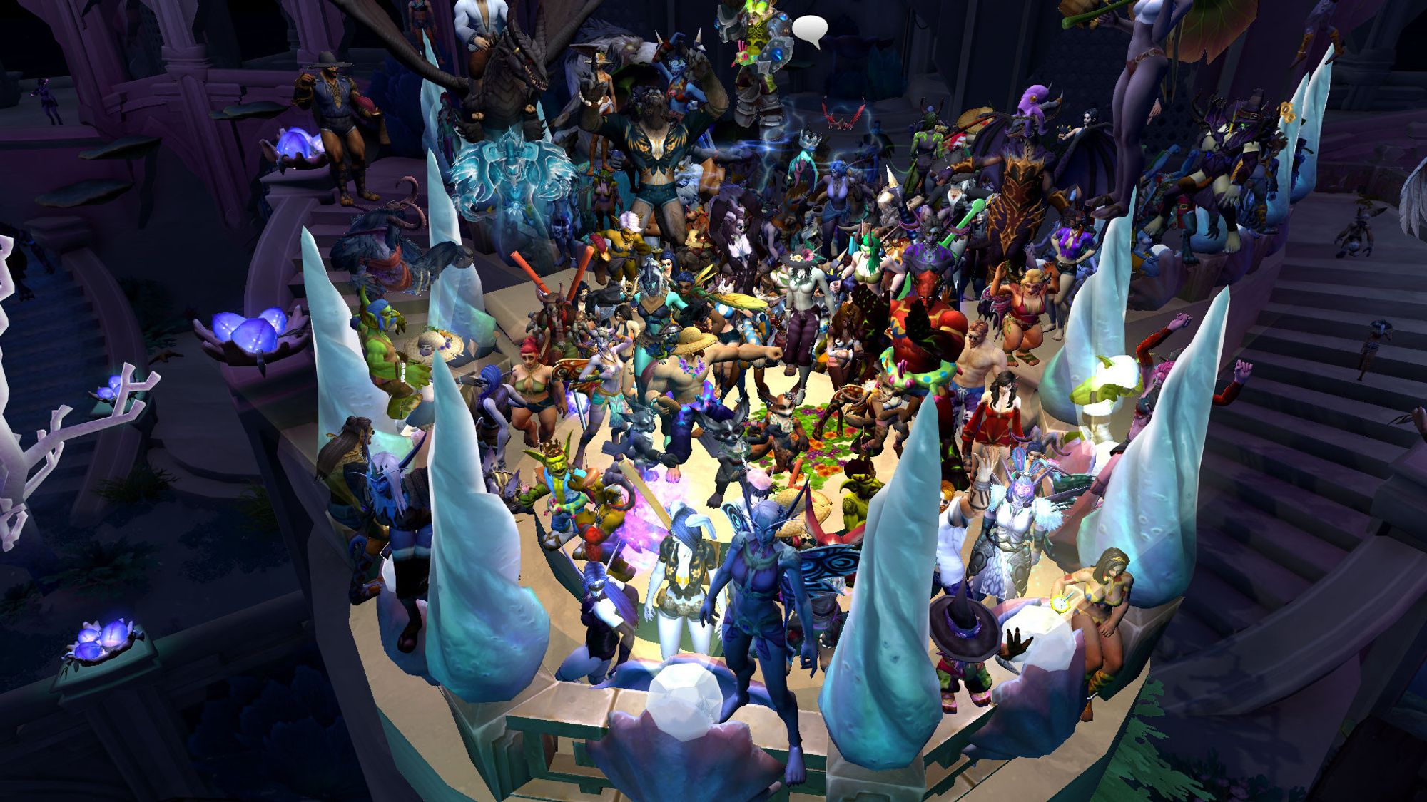 A Warcraft screenshot of many, many players crammed into a small stage atop a life sized sand castle, among them a certain green eyed black furred vulpera.