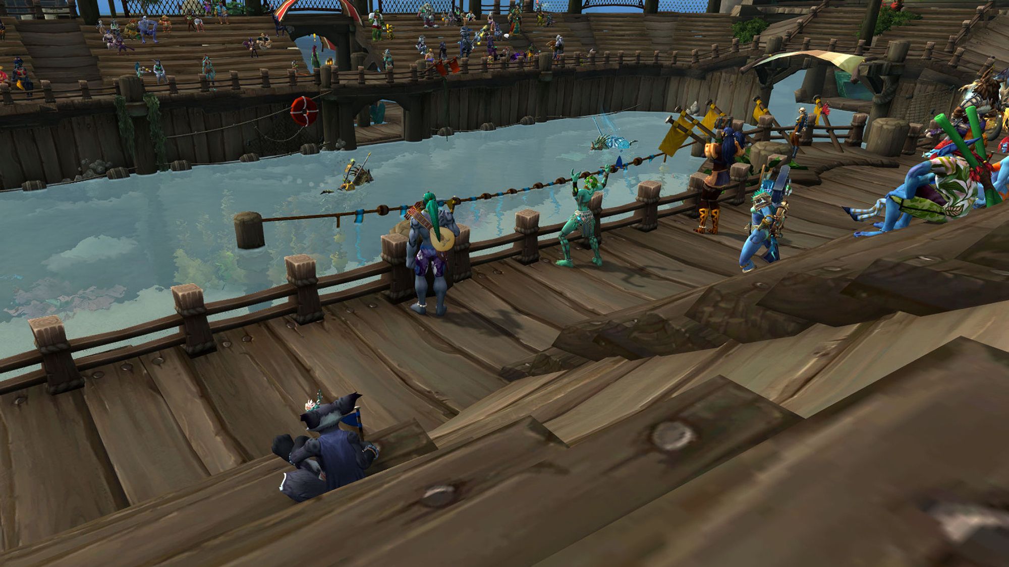 A Warcraft screenshot of a black furred vulpera in a blue cape overlooking a wooden arena with a water filled jousting ring in the center.