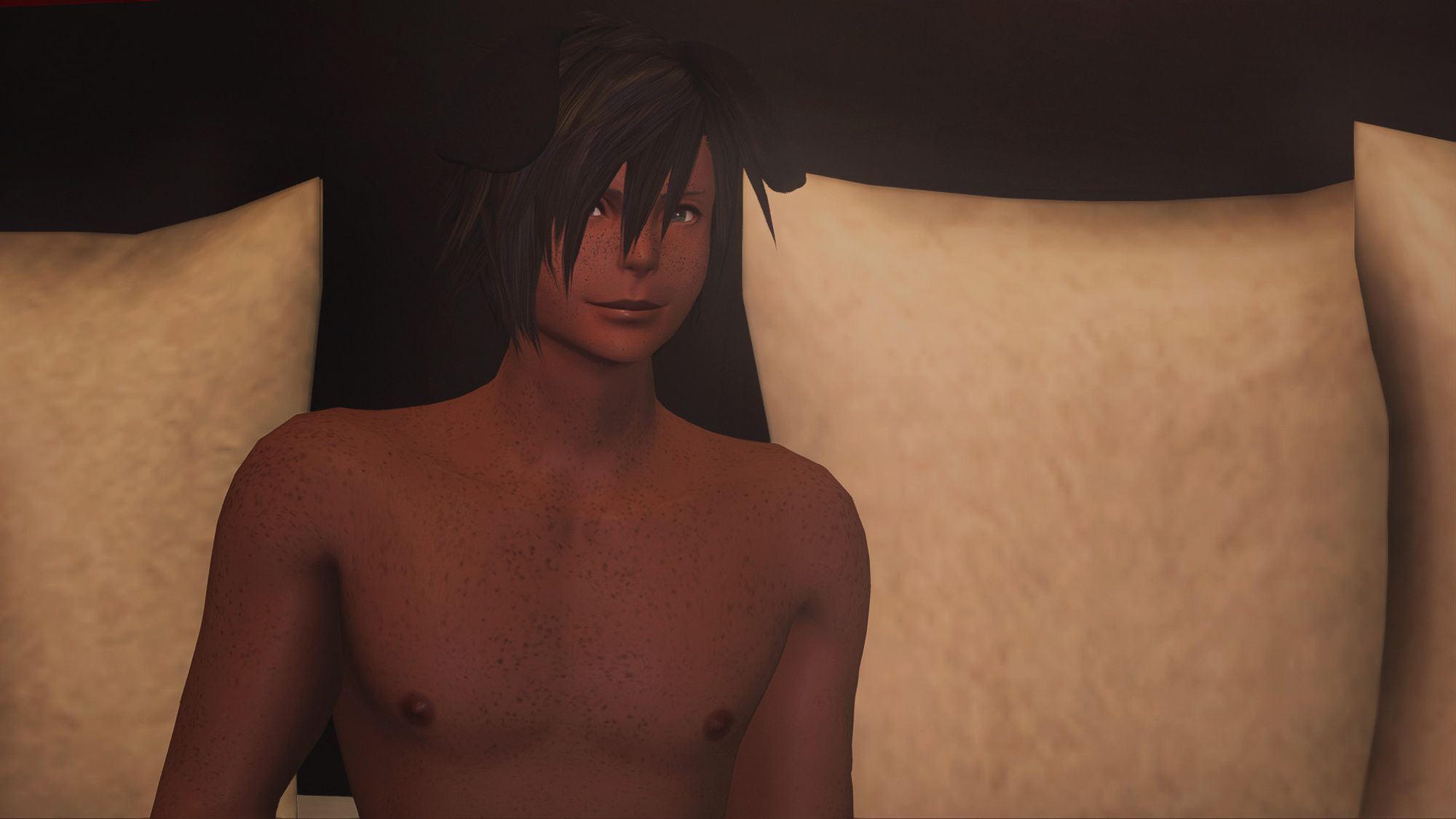 A FFXIV screenshot of a wolfboy with medium brown freckled skin, green eyes, black hair, and floppy black canine ears, pictured shirtless, from the mid-chest up, against a simple backdrop of some pillows.