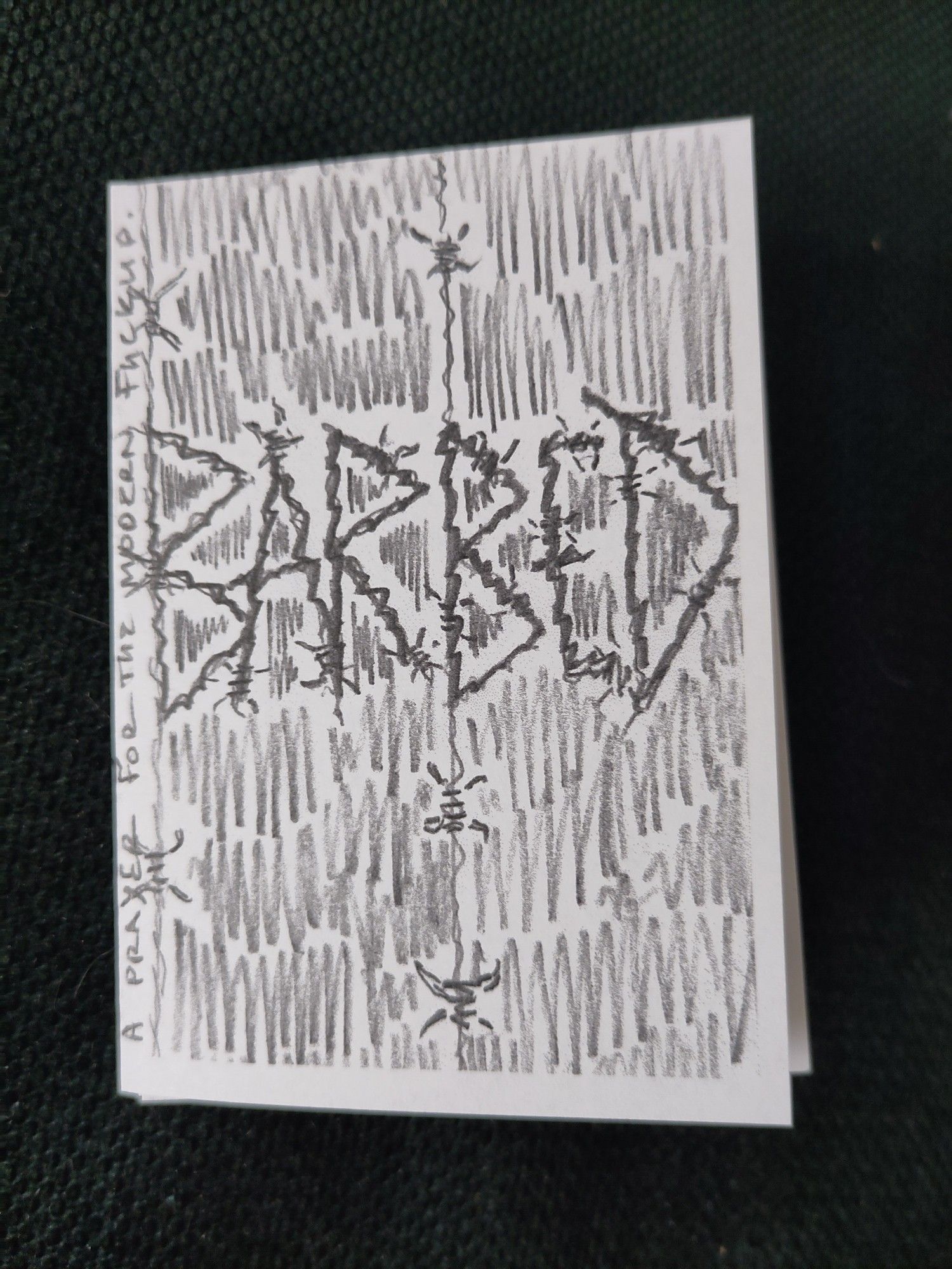 A mini zine titled barbed, the words are formed with barbed wire, the byline says 'a prayer for the modern fuckup'