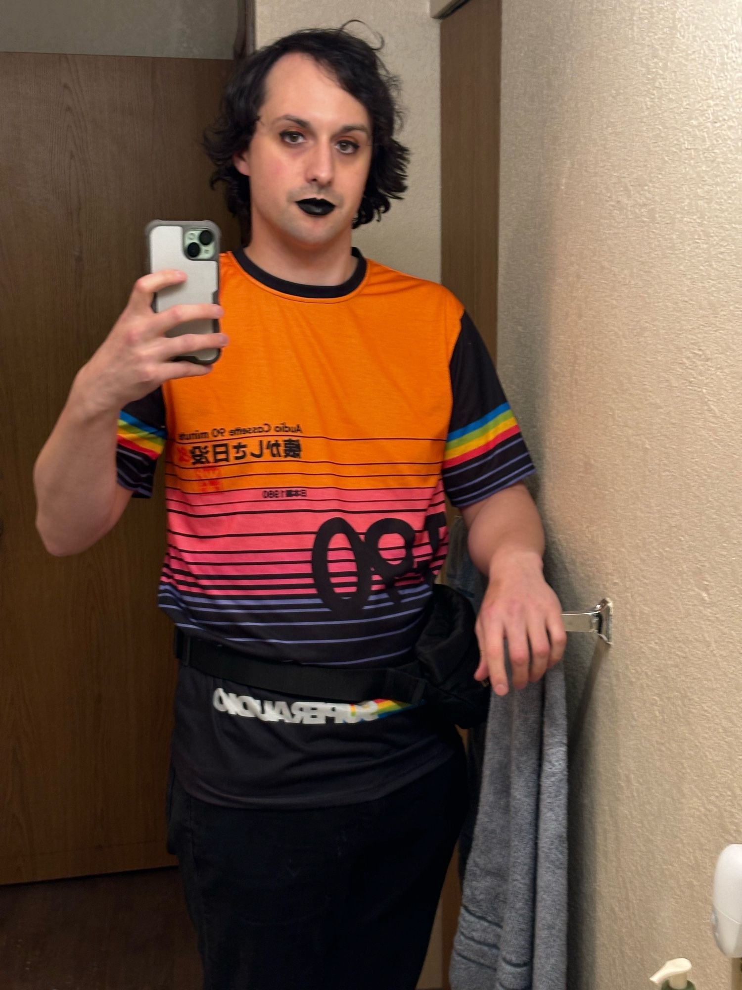 Charlie wearing a sick shirt that has the same pattern as a generic cassette tape paper sleeve, black and orange makeup