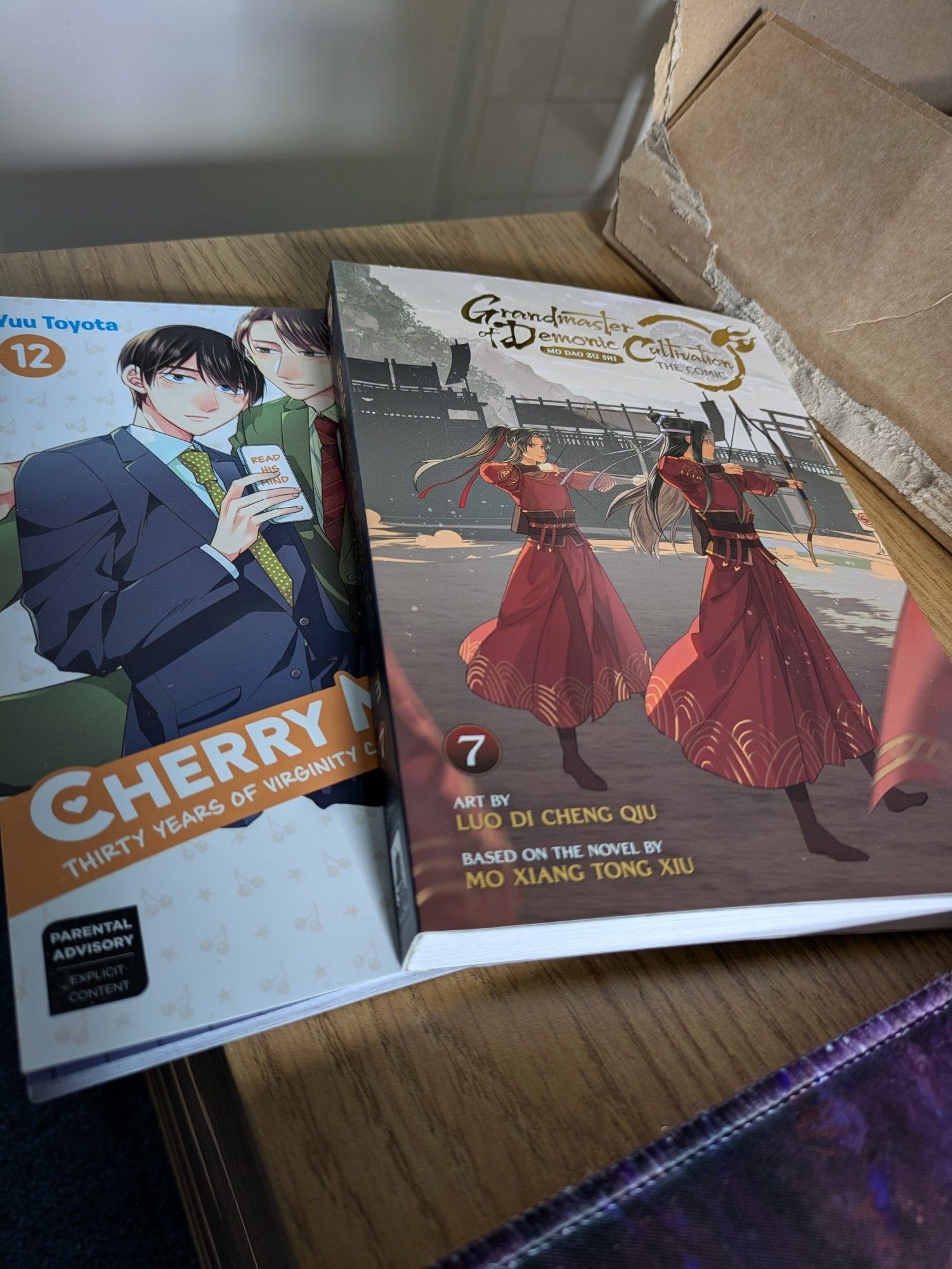 Two newly delivered books; Grandmaster of demonic cultivation comic volume 7 and Cherry magic manga volume 12