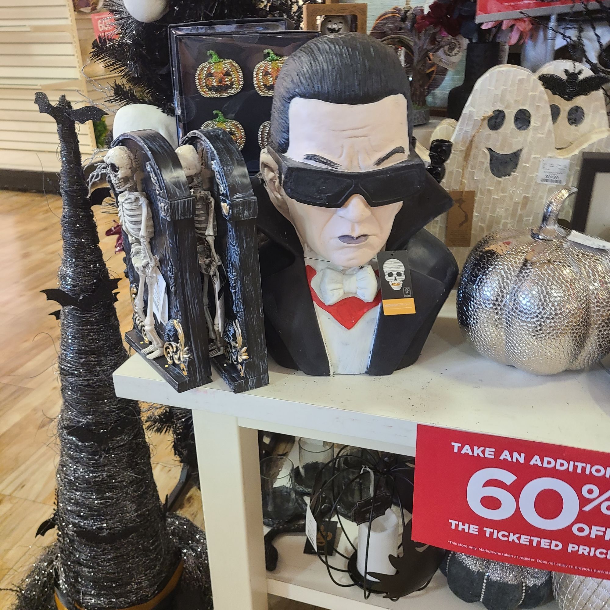 A display of discount goods at a Homewood store. Prominently featured I'm the middle is a vampire bust that looks eerily like Dracula Flow.