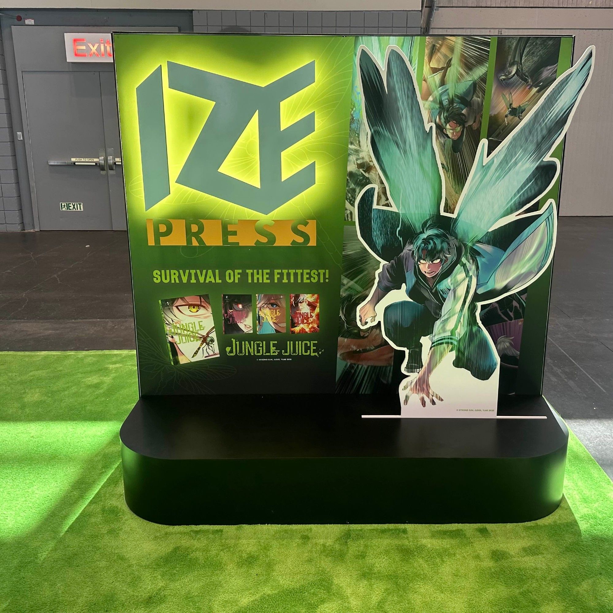 Jungle Juice display at Ize Press during Anime NYC 2024. Featuring jumbo dragonfly insect-human Suchan Jang in an attack position.