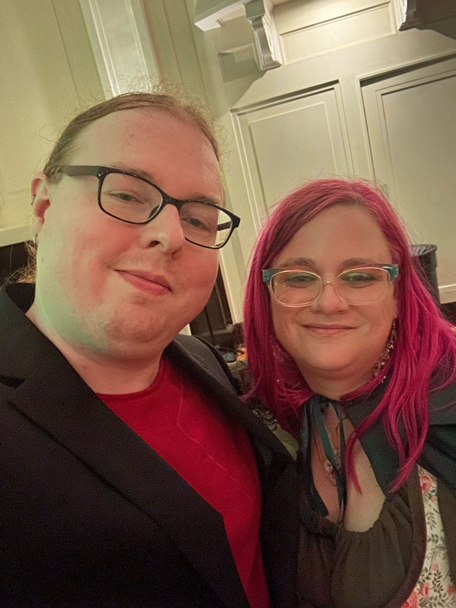 Picture of the spouse and me! They’re in a red shirt and dress jacket for the reception while I’m in a green dress and floral bodice, and have their cape