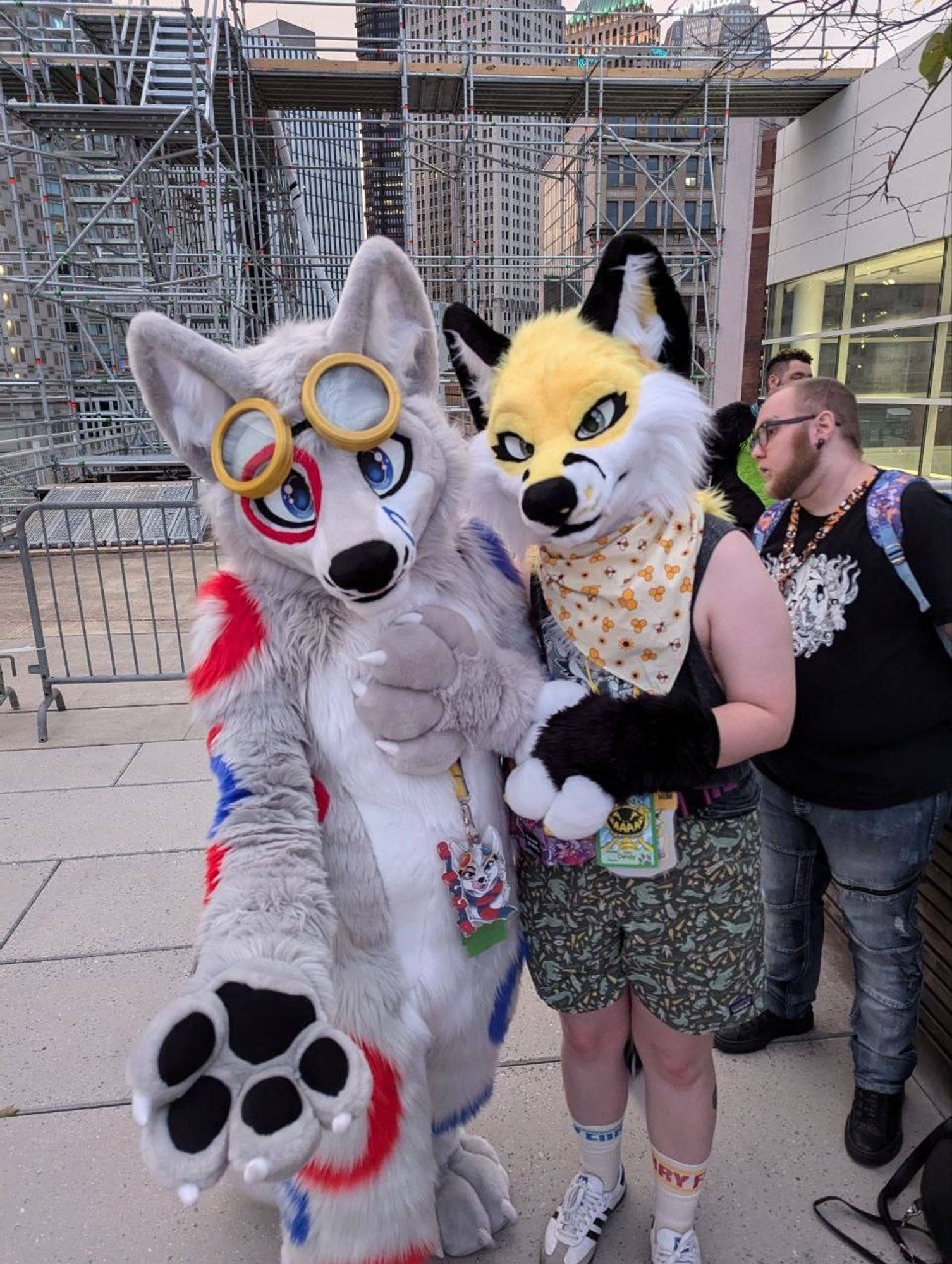 Ringgar (left) and Dandy (right) are posing up on the roof of the Daniel Lawrence Convention Center at Anthrocon 2024!