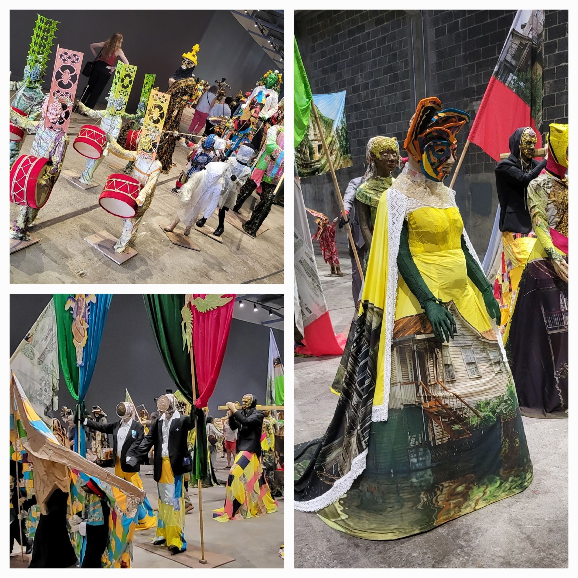 Procession of colorful figures, many with images of Caribbean homes screen printed on to clothes, carrying banners